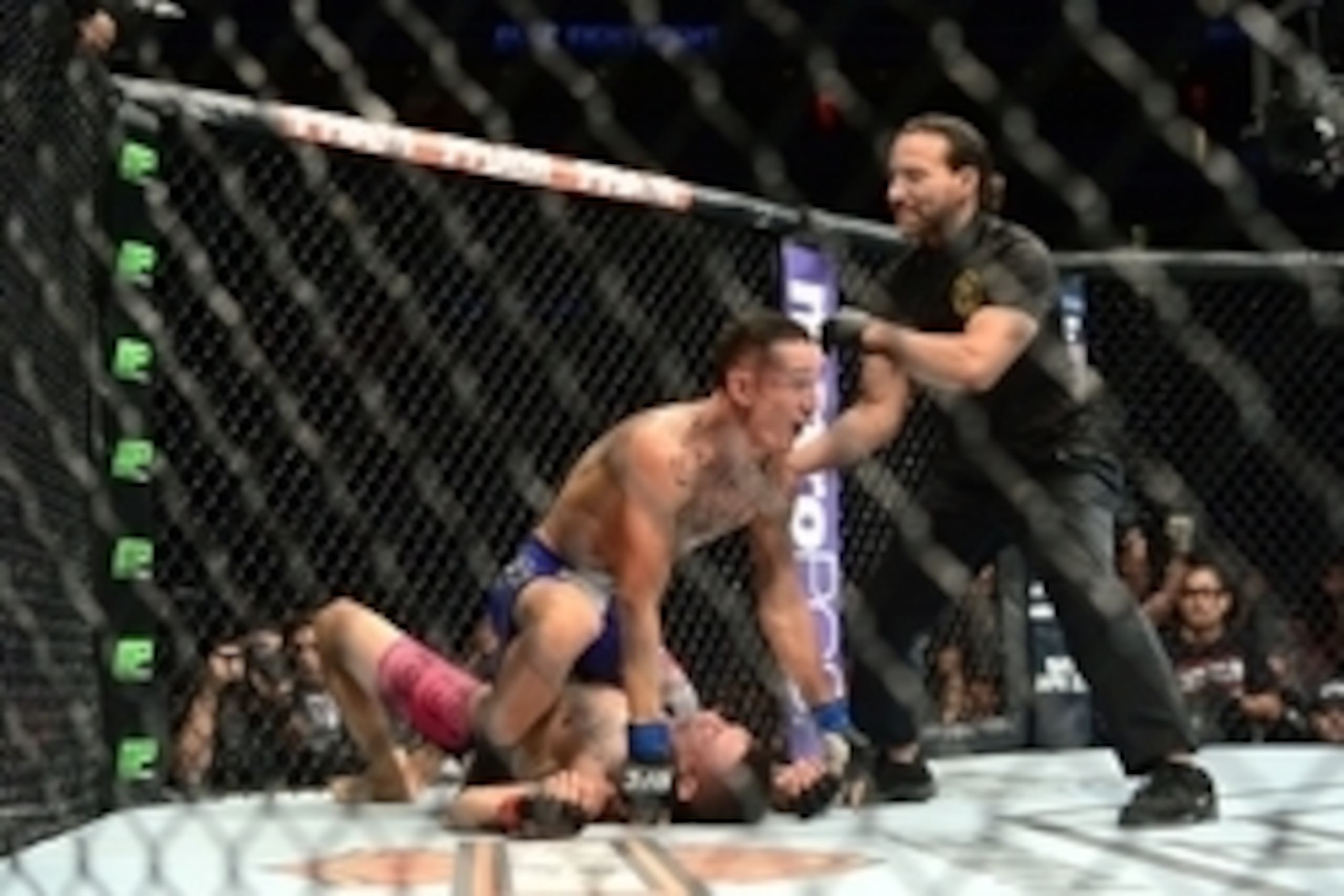 Apr 18, 2015; Newark, NJ, USA; Cub Swanson (red) taps out against Max Holloway (blue) during UFC Fight Night at Prudential Center. Holloway won via third round tap out. Mandatory Credit: Joe Camporeale-USA TODAY Sports