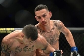 Apr 18, 2015; Newark, NJ, USA; Cub Swanson (red) and Max Holloway (blue) fight during UFC Fight Night at Prudential Center. Holloway won via third round tap out. Mandatory Credit: Joe Camporeale-USA TODAY Sports