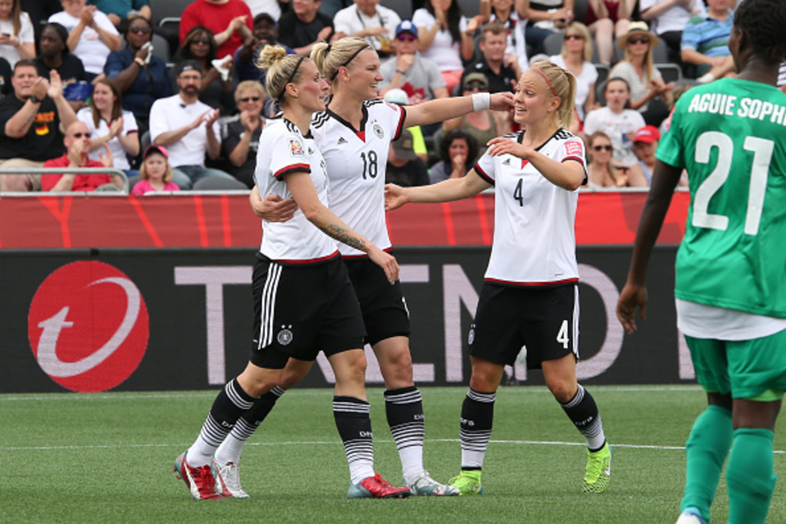 OTTAWA, ON - JUNE 7: Anja Mittag #11, Alexandra Popp #18 and Leonie Maier #4 of Germany celebrate a goal against Cote d'Ivoire during the FIFA Women's World Cup Canada 2015 Group B match between Germany and Cote d'Ivoire at Lansdowne Stadium on June 7, 20