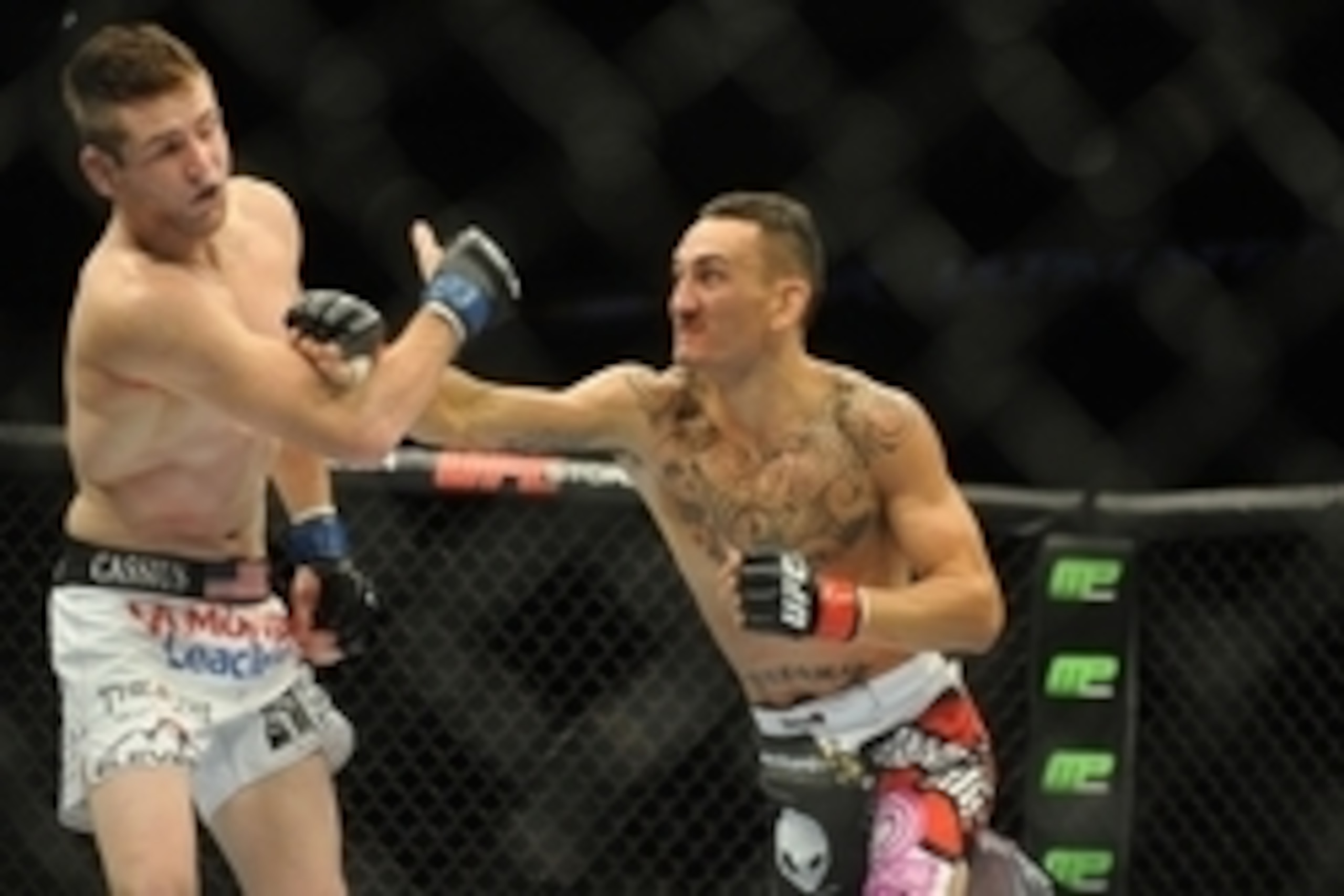 Aug 23, 2014; Tulsa, OK, USA; Max Holloway (red gloves) fights Clay Collard (blue gloves) in a Featherweight Bout at BOK Center. Mandatory Credit: Mark D. Smith-USA TODAY Sports