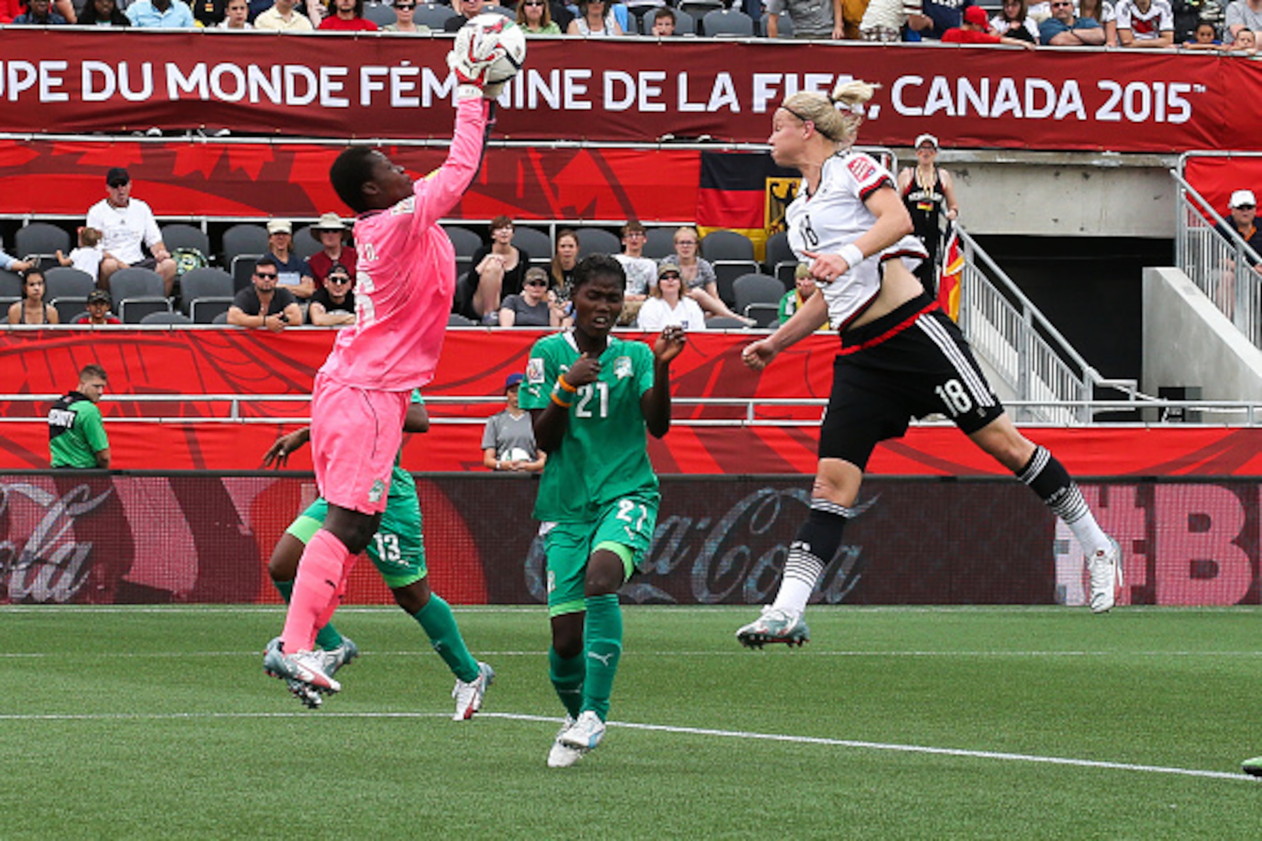 OTTAWA, ON - JUNE 7: Dominique Thiamale #16 of Cote d'Ivoire makes a save on a scoring attempt by Alexandra Popp #18 of Germany with support from teammate Sophie Aguie #21 during the FIFA Women's World Cup Canada 2015 Group B match between Germany and Cot