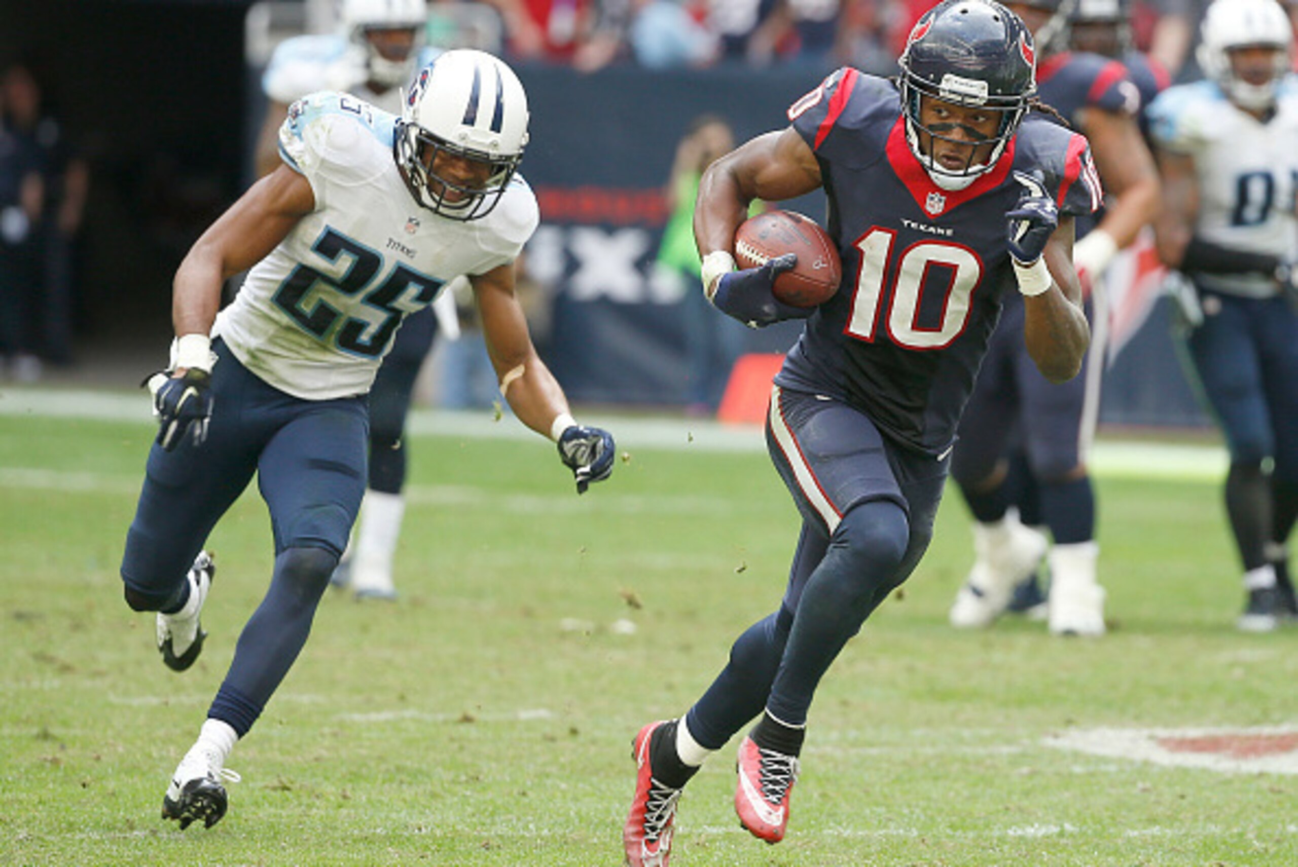 HOUSTON, TX - NOVEMBER 30: DeAndre Hopkins #10 of the Houston Texans runs after the catch while Blidi Wreh-Wilson #25 of the Tennessee Titans chases in the fourth quarter in a NFL game on November 30, 2014 at NRG Stadium in Houston, Texas. (Photo by Scott