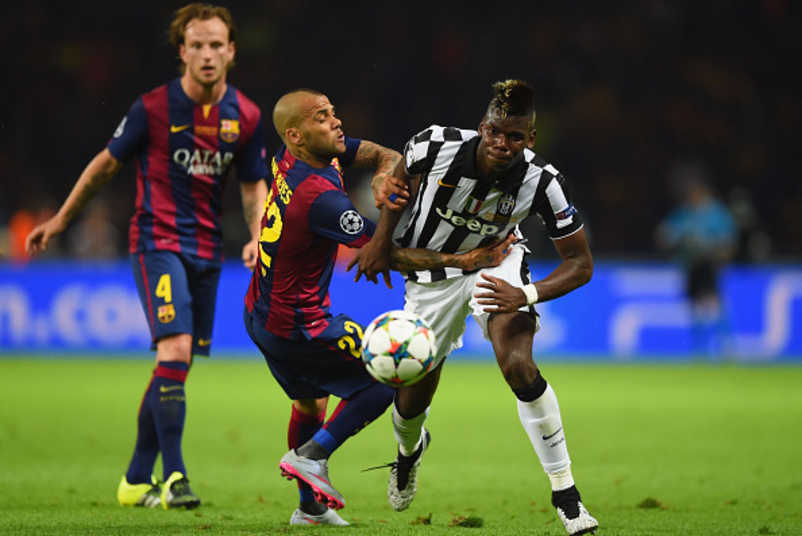 BERLIN, GERMANY - JUNE 06: Paul Pogba of Juventus battles for the ball with Daniel Alves of Barcelona during the UEFA Champions League Final between Juventus and FC Barcelona at Olympiastadion on June 6, 2015 in Berlin, Germany.  (Photo by Shaun Botterill