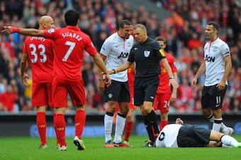 LIVERPOOL, ENGLAND - SEPTEMBER 23: Rio Ferdinand of Manchester United speaks to referee Mark Halsey before Jonjo Shelvey of Liverpool is sent off during the Barclays Premier League match between Liverpool and Manchester United at Anfield on September 23, 