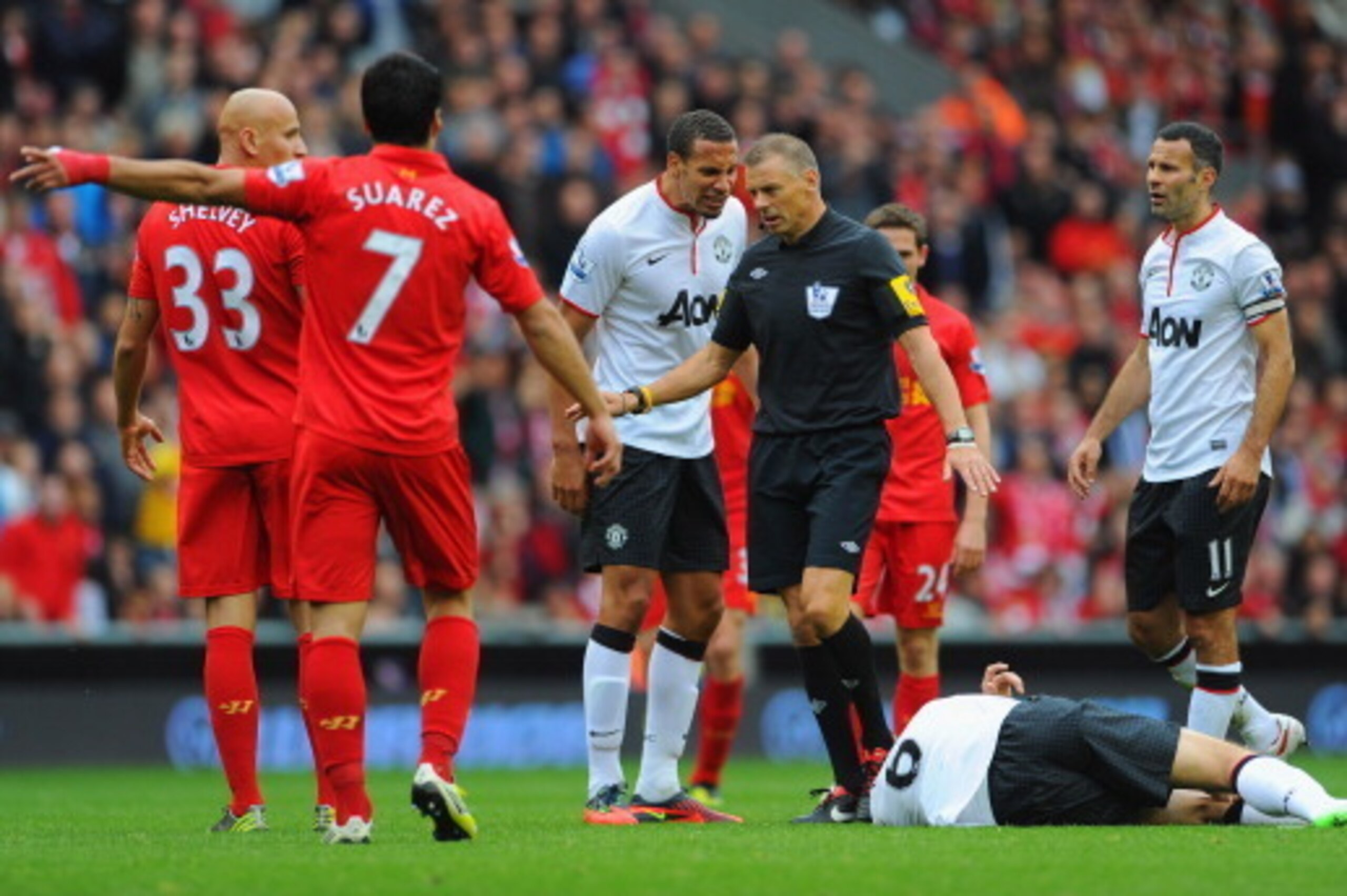 LIVERPOOL, ENGLAND - SEPTEMBER 23: Rio Ferdinand of Manchester United speaks to referee Mark Halsey before Jonjo Shelvey of Liverpool is sent off during the Barclays Premier League match between Liverpool and Manchester United at Anfield on September 23, 