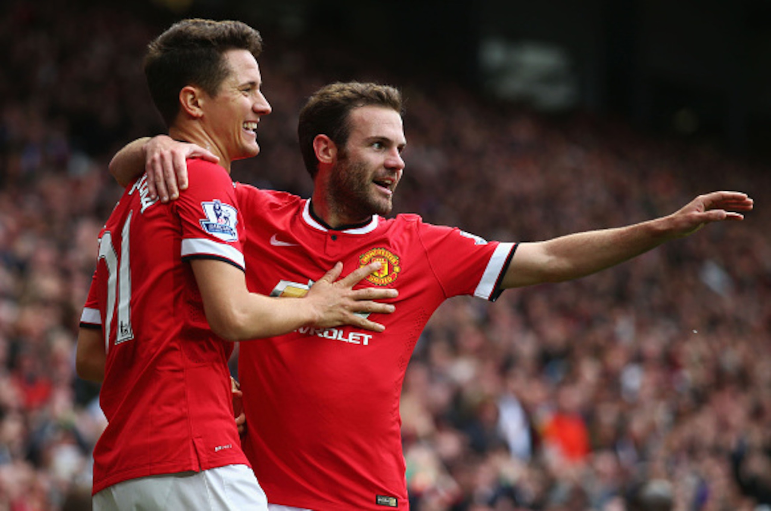 MANCHESTER, ENGLAND - MAY 17:  Ander Herrera of Manchester United celebrates with Juan Mata (R) as he scores their first goal during the Barclays Premier League match between Manchester United and Arsenal at Old Trafford on May 17, 2015 in Manchester, Eng