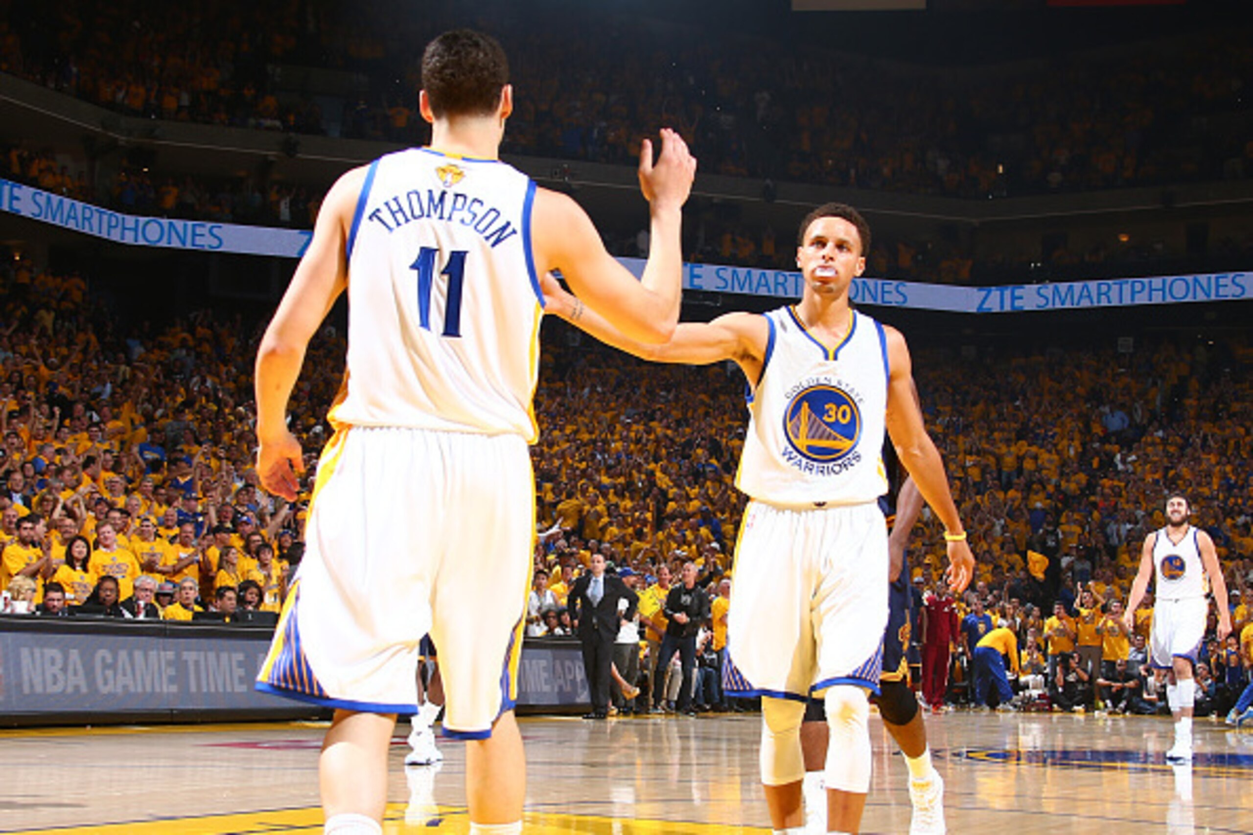 OAKLAND, CA - JUNE 4: Teammates Klay Thompson #11 of the Golden State Warriors and Stephen Curry #30 of the Golden State Warriors high-five during Game One of the 2015 NBA Finals on June 4, 2015 at Oracle Arena in Oakland, California. NOTE TO USER: User e