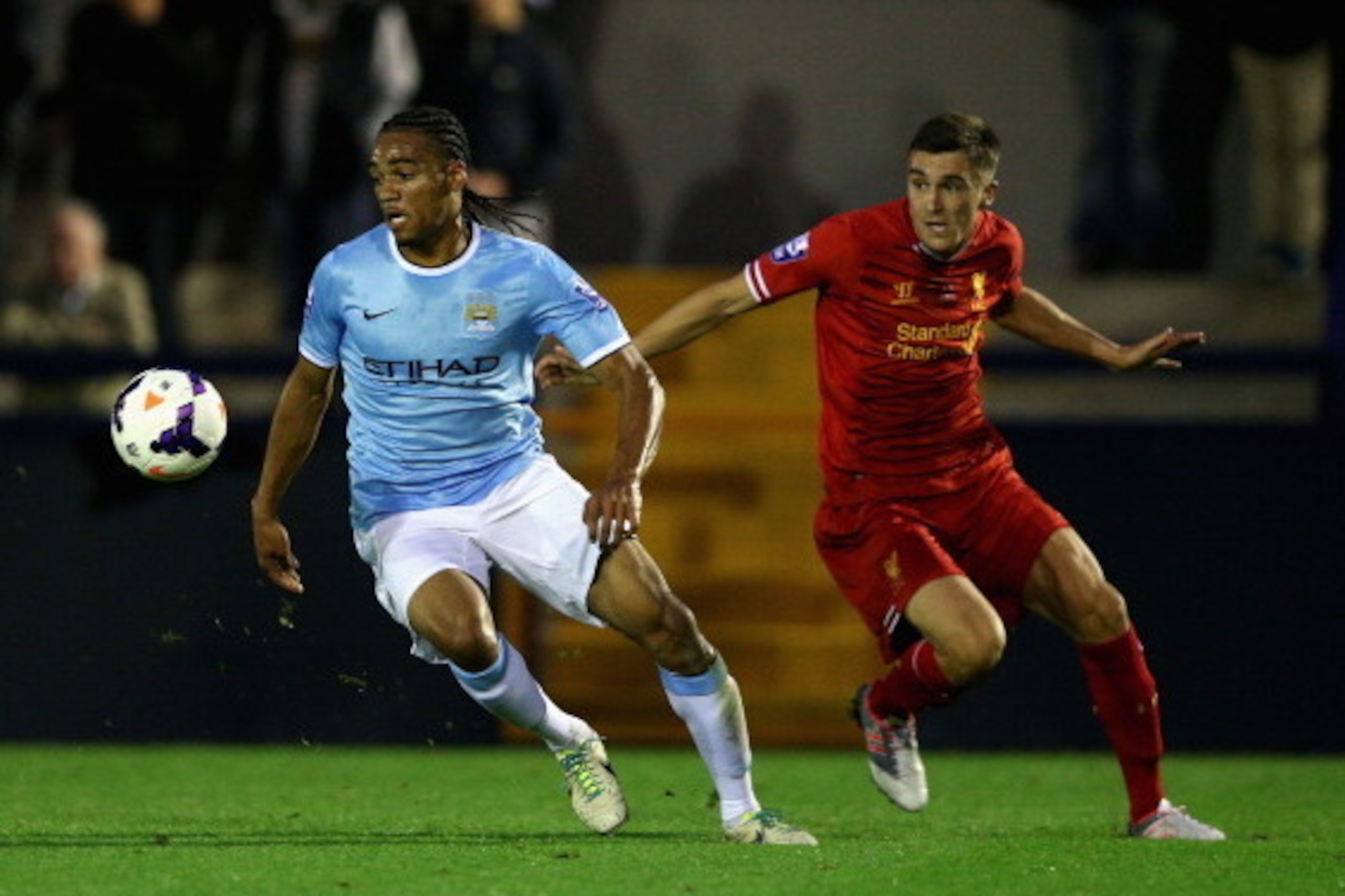 HYDE, ENGLAND - SEPTEMBER 23: Jason Denayer of Manchester City U21 in action with Adam Morgan of Liverpool U21 during the Barclays U21s Premier League match between Manchester City U21 and Liverpool U21 at Ewen Fields on September 23, 2013 in Hyde, Englan