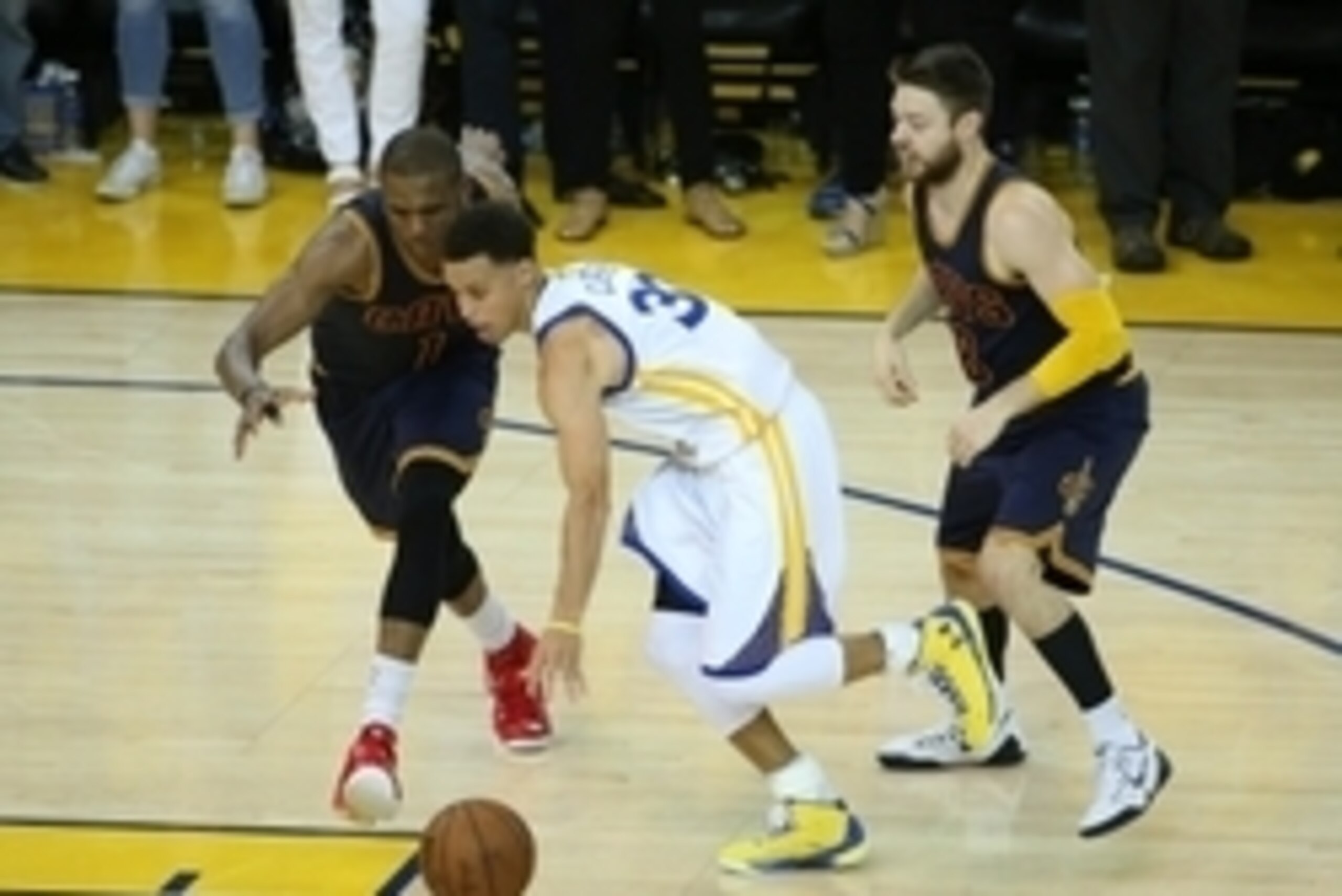June 4, 2015; Oakland, CA, USA; Golden State Warriors guard Stephen Curry (30) moves the ball against the defense of Cleveland Cavaliers forward James Jones (1) and guard Matthew Dellavedova (8) during the overtime period in game one of the NBA Finals. at