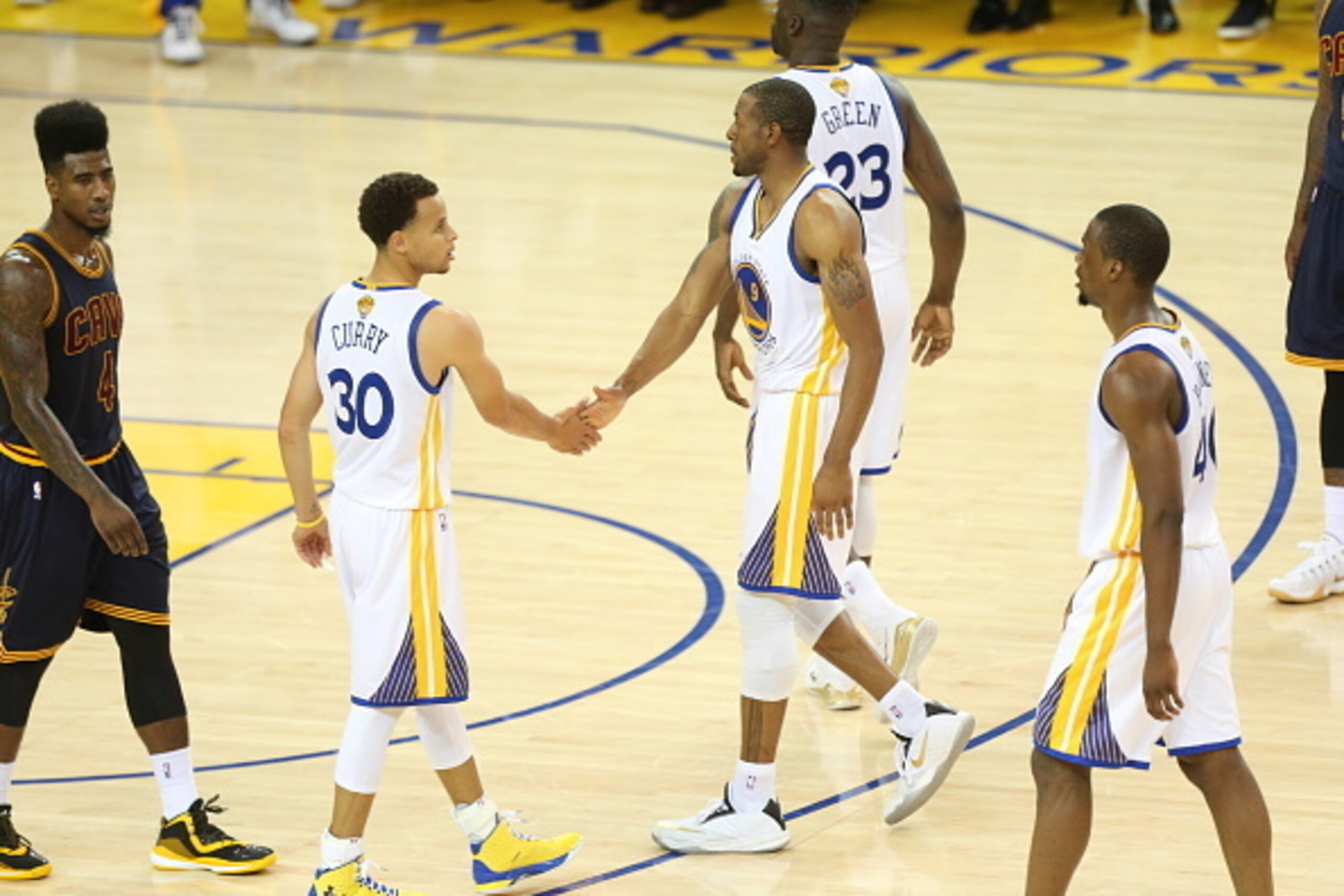 OAKLAND, CA - JUNE 7:  Stephen Curry #30 and Andre Iguodala #9 of the Golden State Warriors shake hands during the game against the Cleveland Cavaliers in Game Two of the 2015 NBA Finals on June 7, 2015 at ORACLE Arena in Oakland, California. NOTE TO USER