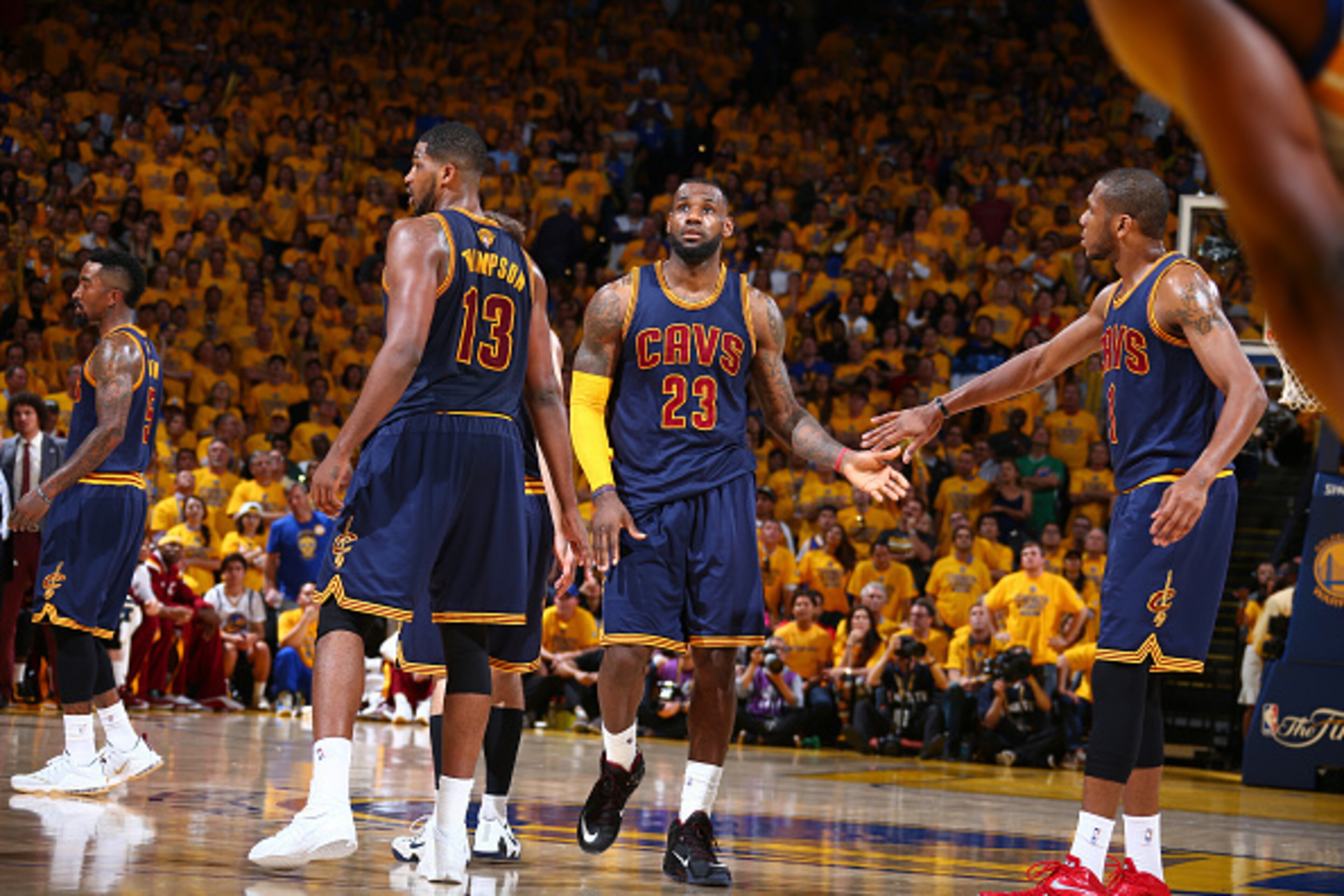 OAKLAND, CA - JUNE 7: Teammates Tristan Thompson #13, LeBron James #23, and James Jones #1 of the Cleveland Cavaliers high-five during Game Two of the 2015 NBA Finals on June 7, 2015 at Oracle Arena in Oakland, California. NOTE TO USER: User expressly ack