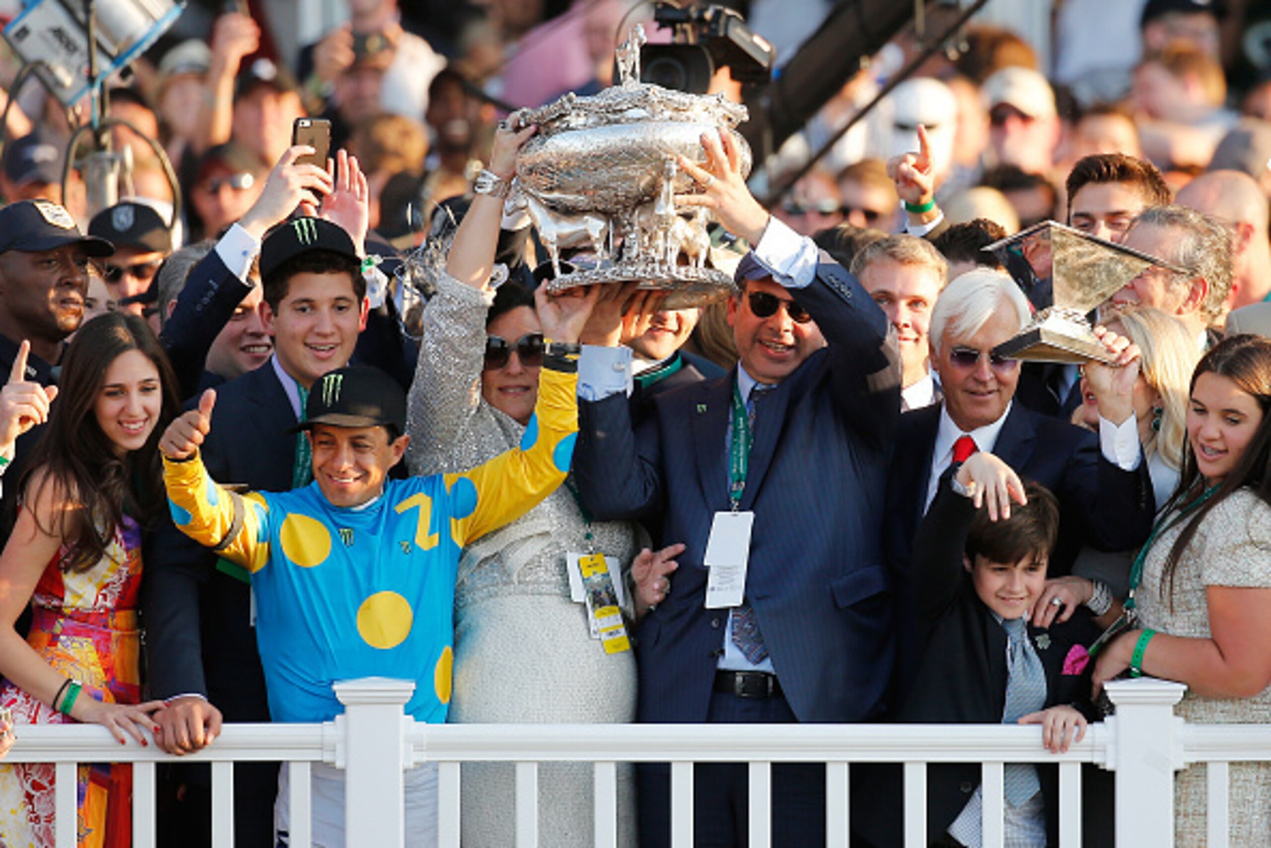 ELMONT, NY - JUNE 06:  Victor Espinoza (L), jockey of American Pharoah #5, owner of Ahmed Zayat, and trainer Bob Baffert (R), celebrate with the Belmont Stakes and Triple Crown Trophies after winning the 147th running of the Belmont Stakes at Belmont Park