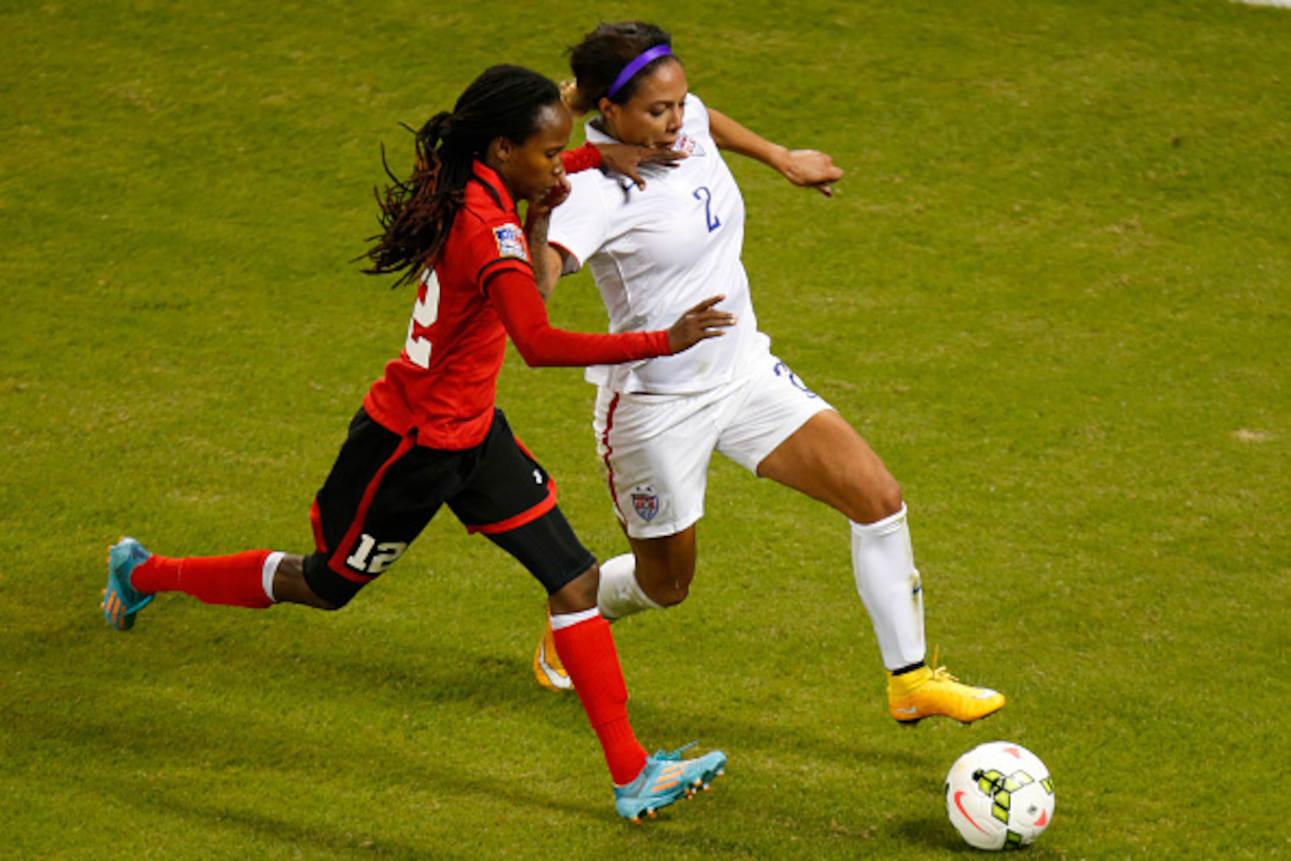 KANSAS CITY, KS - OCTOBER 15: Ahkeela Mollon #12 of Trinidad & Tobago defends against Sydney Leroux #2 of United States late in the second half second half of the CONCACAF Women's Championship USA 2014 on October 15, 2014 at Sporting Park in Kansas City, 