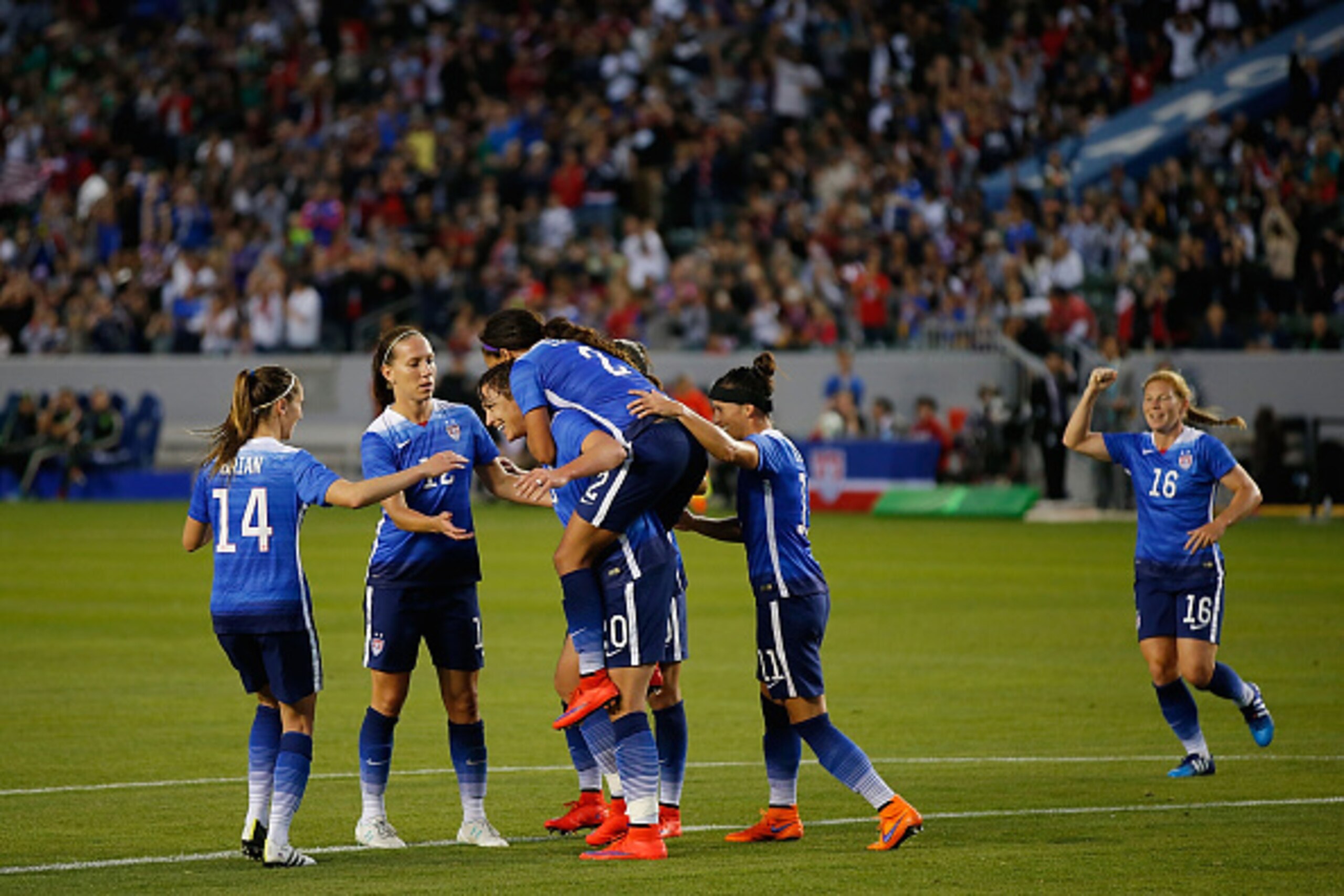 LOS ANGELES, CA - MAY 17:  Forward Sydney Leroux #2 of USA jumps on Forward Abby Wambach #20 back and celebrates her goal with the team 
against Mexico during their international friendly match at StubHub Center on May 17, 2015 in Los Angeles, California.