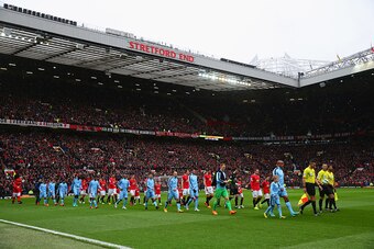 MANCHESTER, ENGLAND - APRIL 12:  Officials and players walk on to the pitch prior to the Barclays Premier League match between Manchester United and Manchester City at Old Trafford on April 12, 2015 in Manchester, England.  (Photo by Alex Livesey/Getty Im