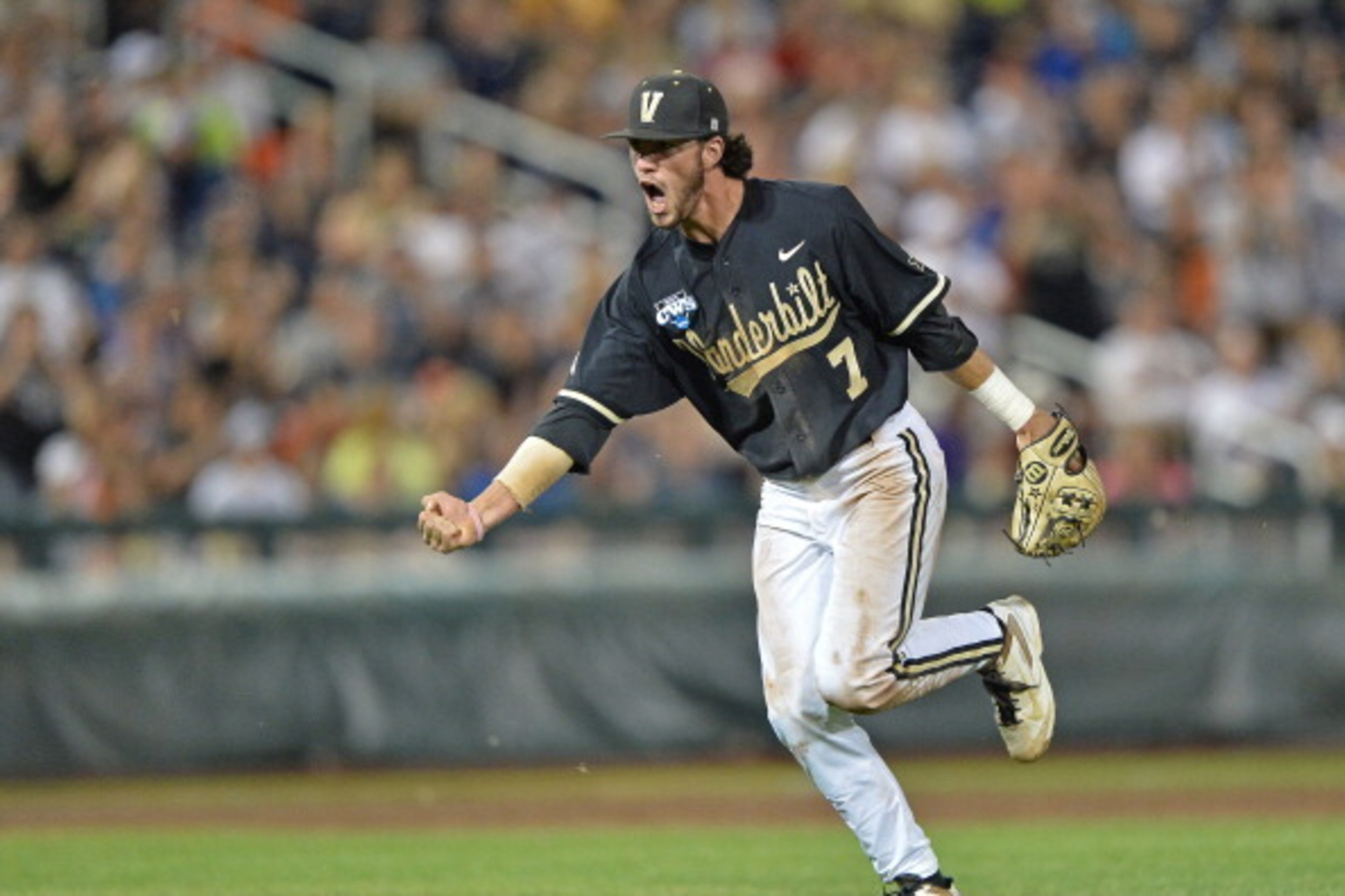 Omaha, NE - JUNE 25:  Second basemen Dansby Swanson #7 of the Vanderbilt Commodores celebrates after recording the final out of the eighth inning against the Virginia Cavaliers during game three of the College World Series Championship Series on June 25, 