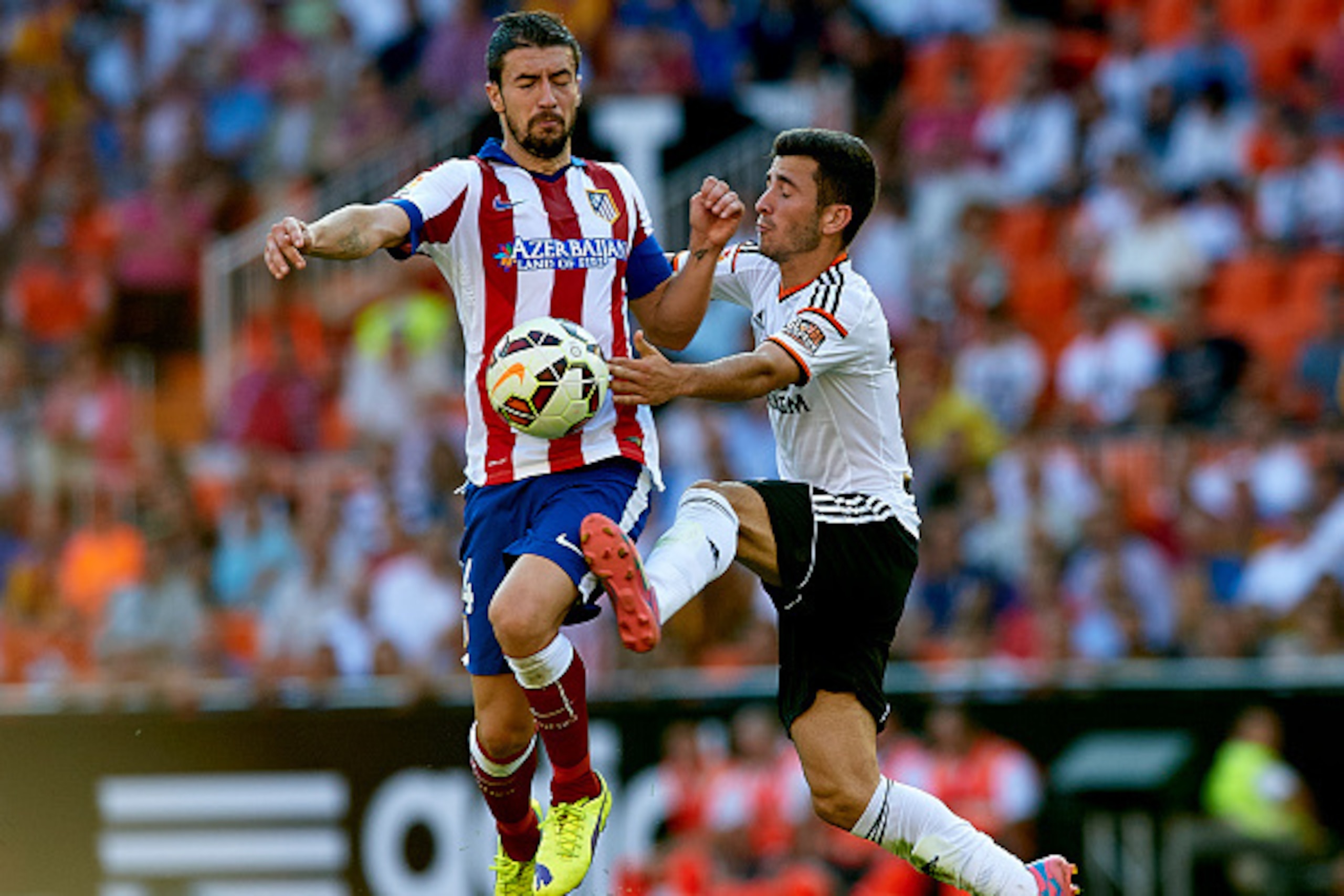 VALENCIA, SPAIN - OCTOBER 04: Gabi (L) of Atletico de Madrid is tackled by Jose Gaya of Valencia during the La Liga match between Valencia CF and Club Atletico de Madrid at Estadi de Mestalla on October 4, 2014 in Valencia, Spain. (Photo by Manuel Queim VALENCIA, SPAIN - OCTOBER 04: Gabi (L) of Atletico de Madrid is tackled by Jose Gaya of Valencia during the La Liga match between Valencia CF and Club Atletico de Madrid at Estadi de Mestalla on October 4, 2014 in Valencia, Spain. (Photo by Manuel Queim