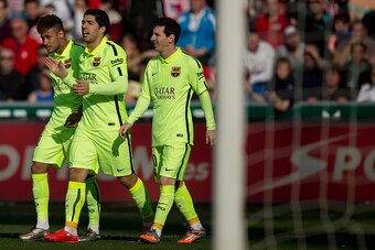 GRANADA, SPAIN - FEBRUARY 28: Luis Suarez (C) celebrates scoring their second goal with team mates Neymar JR. (L) and Lionel Messi (R) during the La Liga match between Granada CF and FC Barcelona at Nuevo Estadio de los Carmenes on February 28, 2015 in Gr