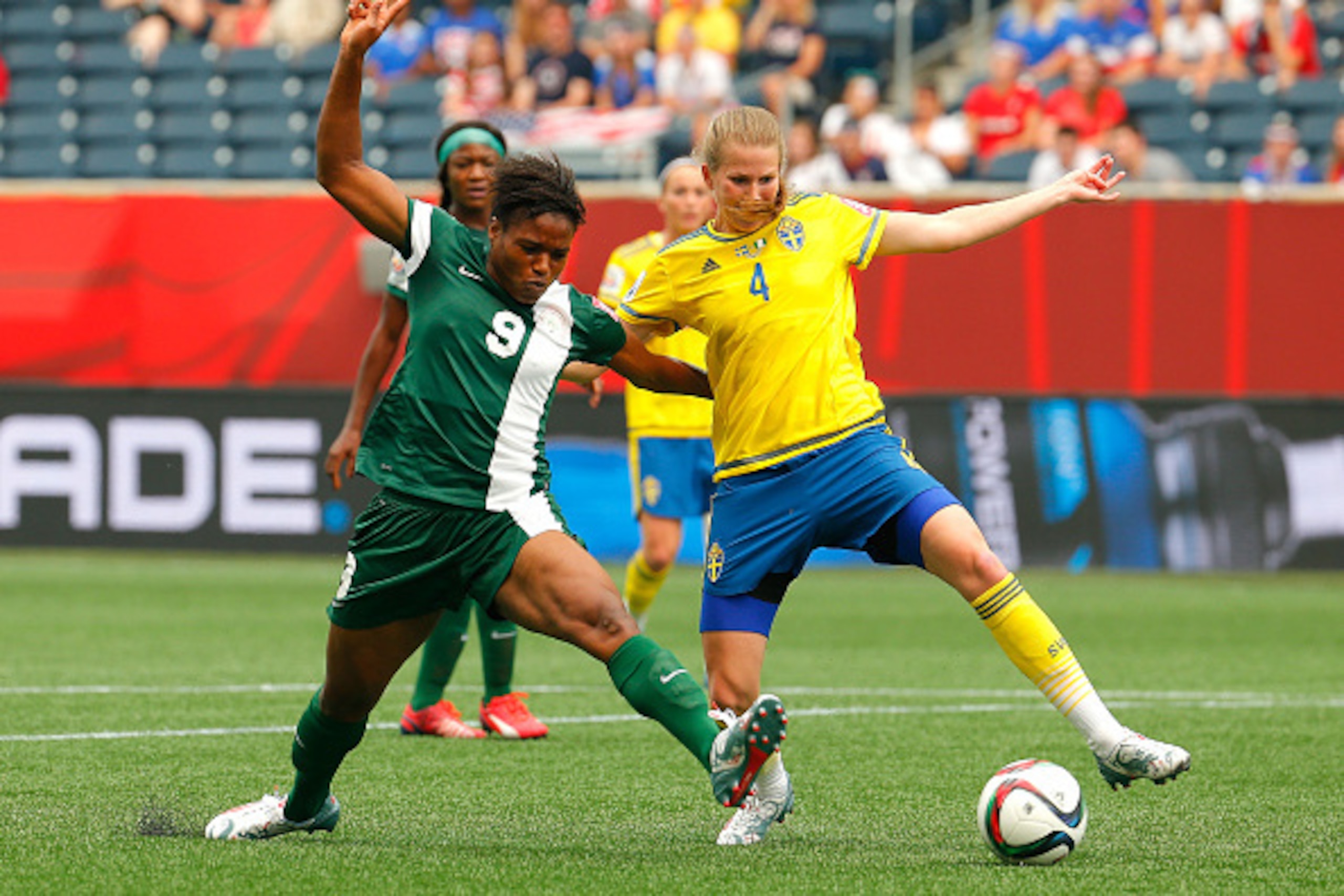 WINNIPEG, MB - JUNE 08: Desire Oparanozie #9 of Nigeria challenges Emma Berglund #4 of Sweden during the FIFA Women's World Cup Canada 2015 Group D match between Sweden and Nigeria at Winnipeg Stadium on June 8, 2015 in Winnipeg, Canada. (Photo by Kevin WINNIPEG, MB - JUNE 08: Desire Oparanozie #9 of Nigeria challenges Emma Berglund #4 of Sweden during the FIFA Women's World Cup Canada 2015 Group D match between Sweden and Nigeria at Winnipeg Stadium on June 8, 2015 in Winnipeg, Canada. (Photo by Kevin