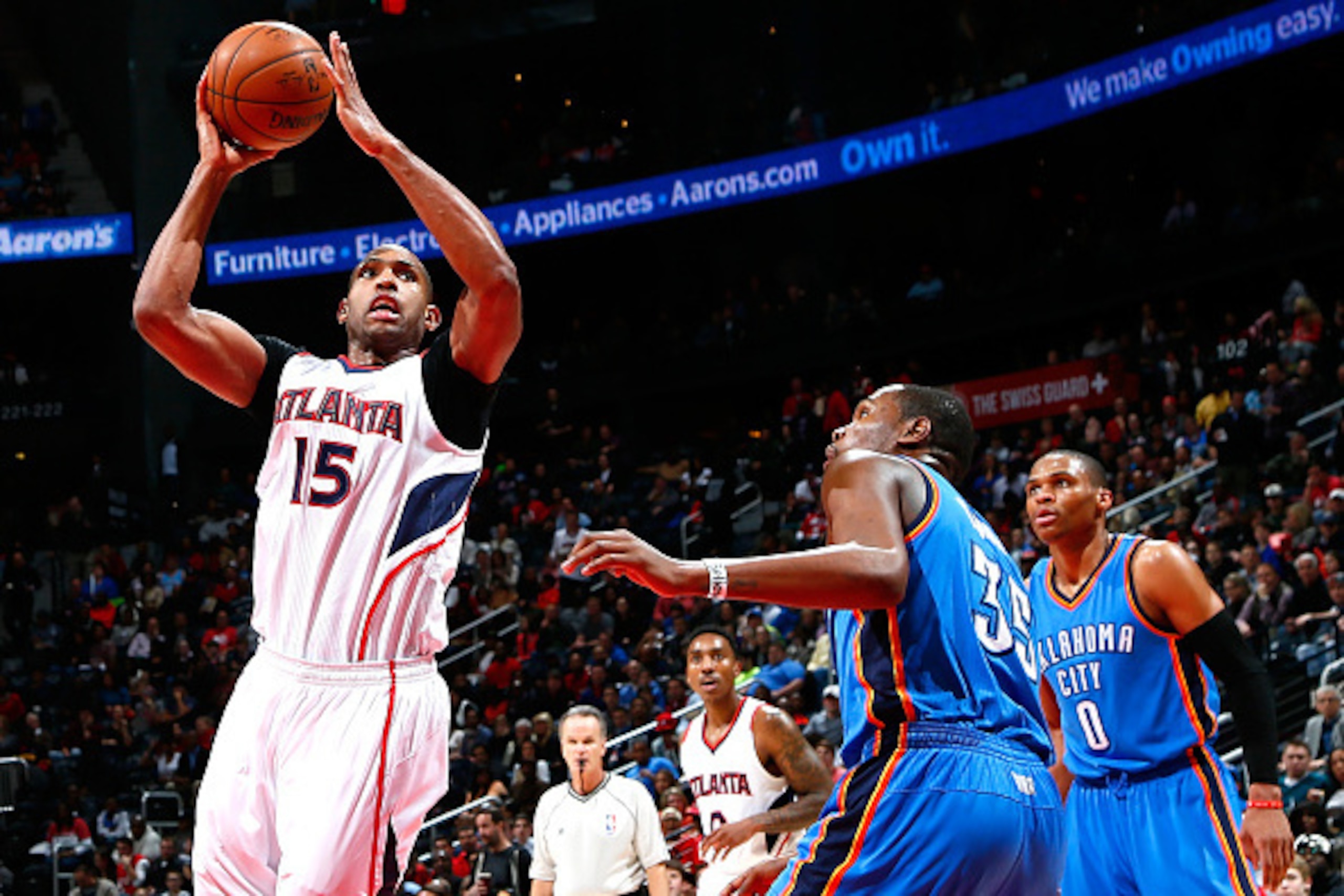 ATLANTA, GA - JANUARY 23:  Al Horford #15 of the Atlanta Hawks shoots against Kevin Durant #35 of the Oklahoma City Thunder at Philips Arena on January 23, 2015 in Atlanta, Georgia.  NOTE TO USER: User expressly acknowledges and agrees that, by downloadin