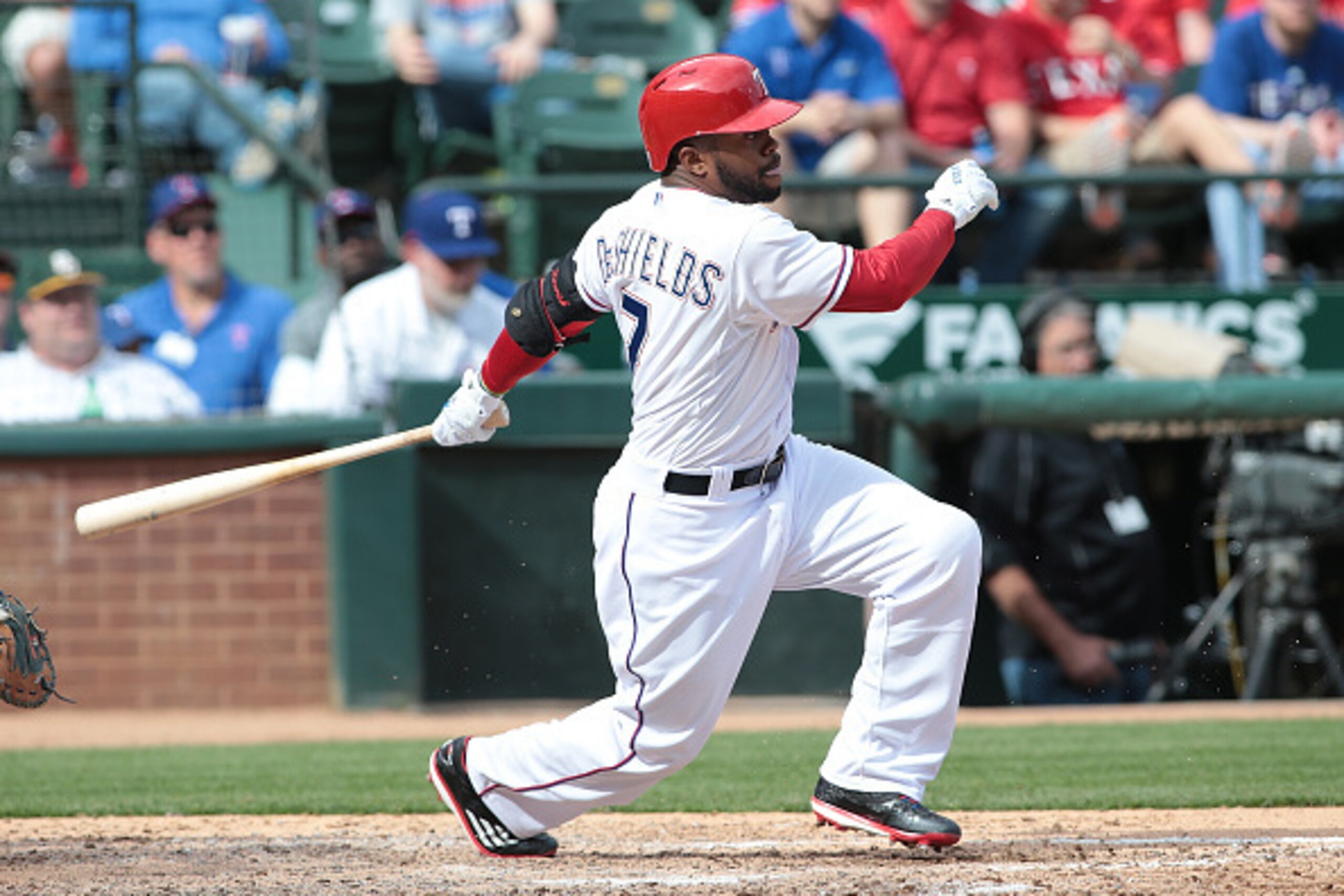 ARLINGTON, TX - APRIL 10: Delino DeShields Jr. #7 of the Texas Rangers hits a fielders choice against the Houston Astros for Adrian Beltre #29 to score in the sixth inning on Rangers opening day game at Globe Life Park in Arlington on April 10, 2015 in Ar