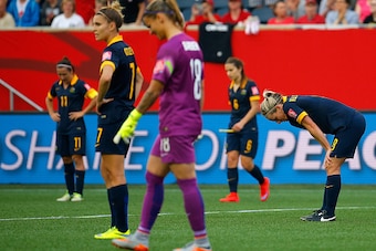 WINNIPEG, MB - JUNE 08:  Gaolkeeper Melissa Barbieri #18 and Elise Kellond-Knight #8 of Australia react after Megan Rapinoe #15 of United States scores her second goal of the match in the second half during the FIFA Women's World Cup 2015 Group D match at