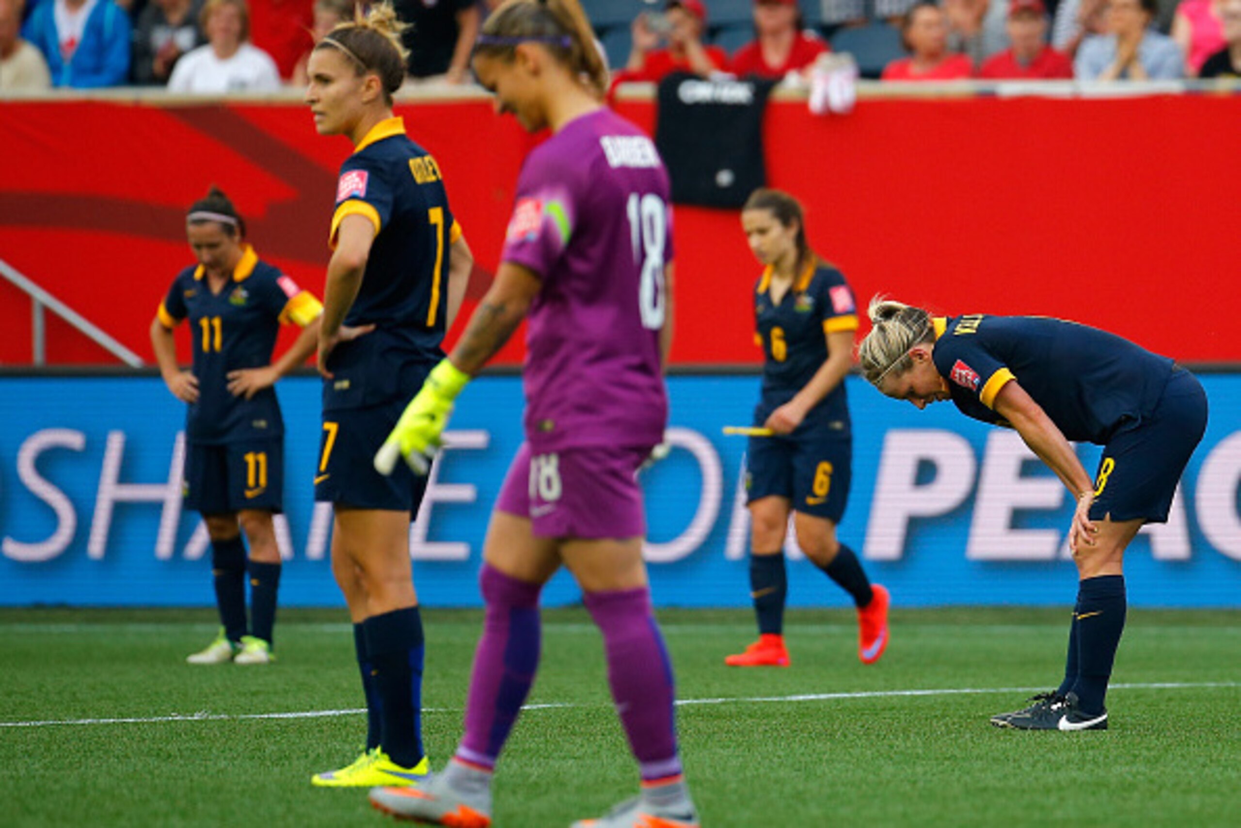 WINNIPEG, MB - JUNE 08:  Gaolkeeper Melissa Barbieri #18 and Elise Kellond-Knight #8 of Australia react after Megan Rapinoe #15 of United States scores her second goal of the match in the second half during the FIFA Women's World Cup 2015 Group D match at