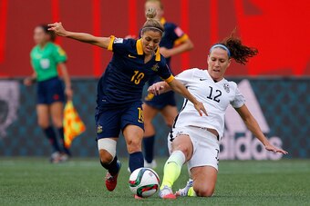 WINNIPEG, MB - JUNE 08:  Katrina Gorry #19 of Australia challenges Lauren Holiday #12 of United States in the first half during the FIFA Women's World Cup 2015 Group D match at Winnipeg Stadium on June 8, 2015 in Winnipeg, Canada.  (Photo by Kevin C. Cox/