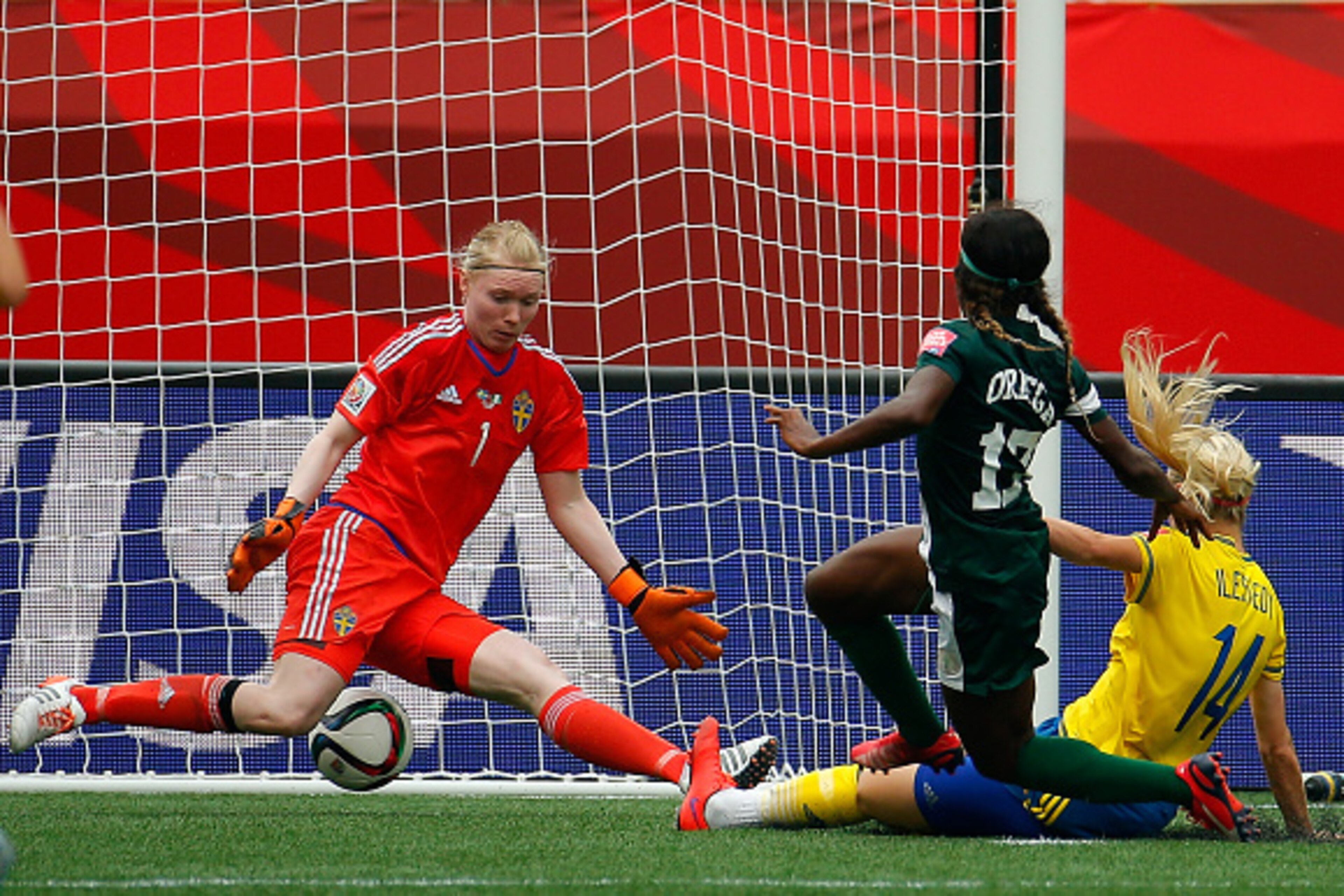 WINNIPEG, MB - JUNE 08:  Francisca Ordega #17 of Nigeria scores the game-tying goal past Amanda Ilestedt #14 and goalkeeper Hedvig Lindahl #1 of Sweden during the FIFA Women's World Cup Canada 2015 Group D match between Sweden and Nigeria at Winnipeg Stad