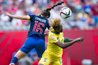 VANCOUVER, BC - MAY 8:  Gaelle Enganamouit #17 of Cameroon and Ligia Moreira #16 of Ecuador battle for the ball during the FIFA Women's World Cup Canada 2015 Group C match between Cameroon and Ecuador June, 8, 2015 at BC Place Stadium in Vancouver, Britis
