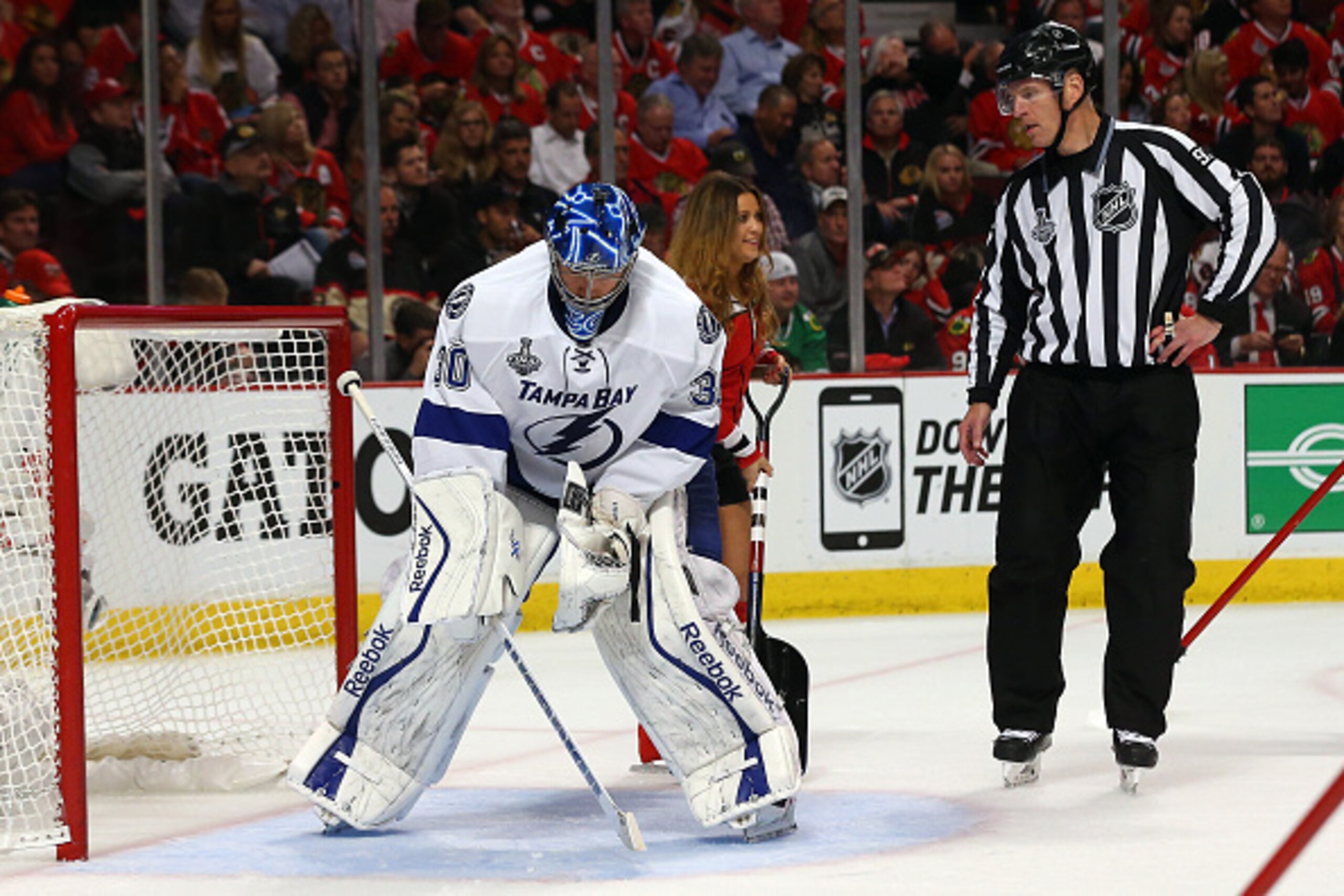 CHICAGO, IL - JUNE 08:  Ben Bishop #30 of the Tampa Bay Lightning stays in position as a member of the ice crew tries to clear the crease during Game Three of the 2015 NHL Stanley Cup Final against the Chicago Blackhawks at the United Center on June 8, 20
