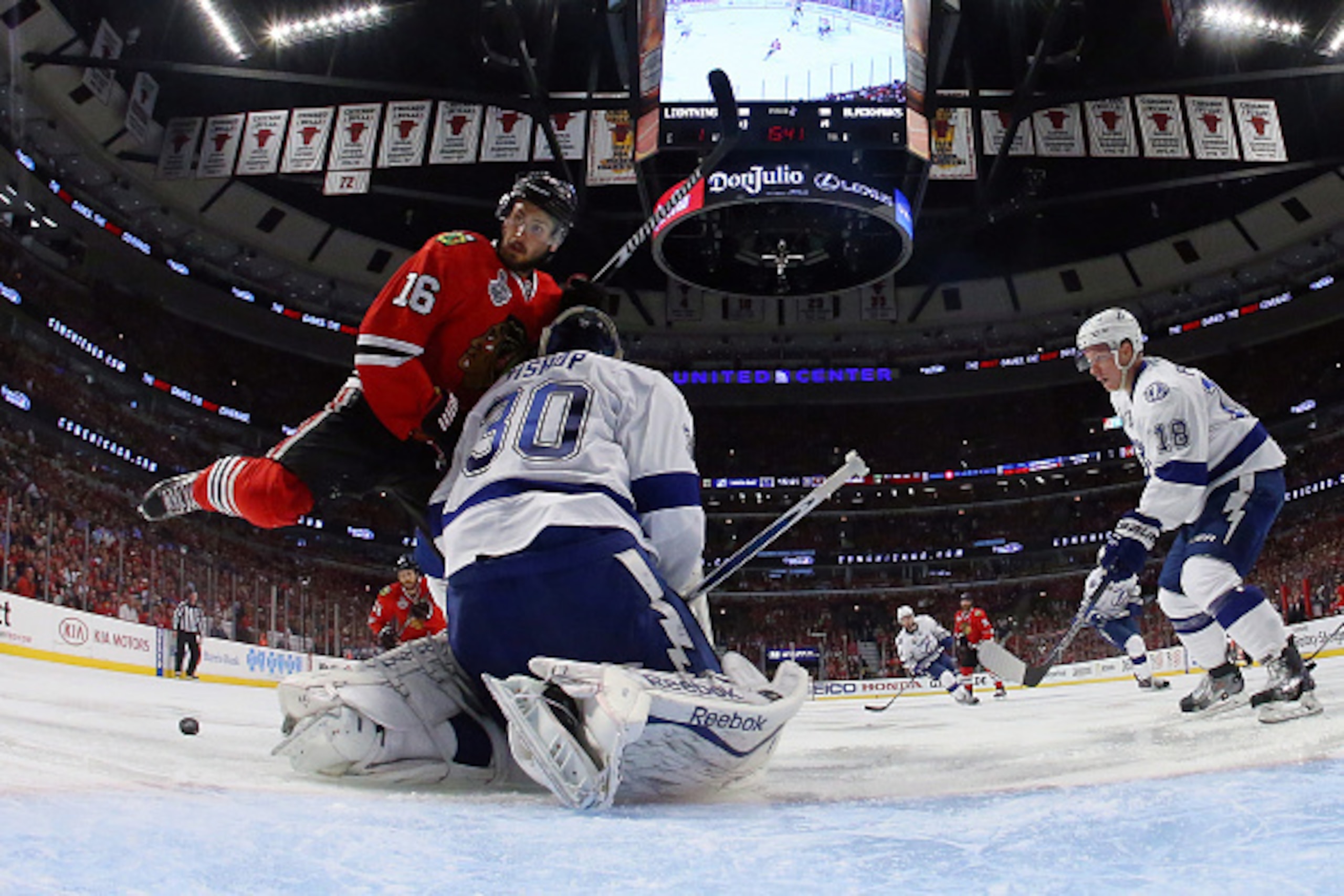 CHICAGO, IL - JUNE 08:  Marcus Kruger #16 of the Chicago Blackhawks gets tangled up with Ben Bishop #30 of the Tampa Bay Lightning during Game Three of the 2015 NHL Stanley Cup Final at the United Center on June 8, 2015 in Chicago, Illinois.  (Photo by Br
