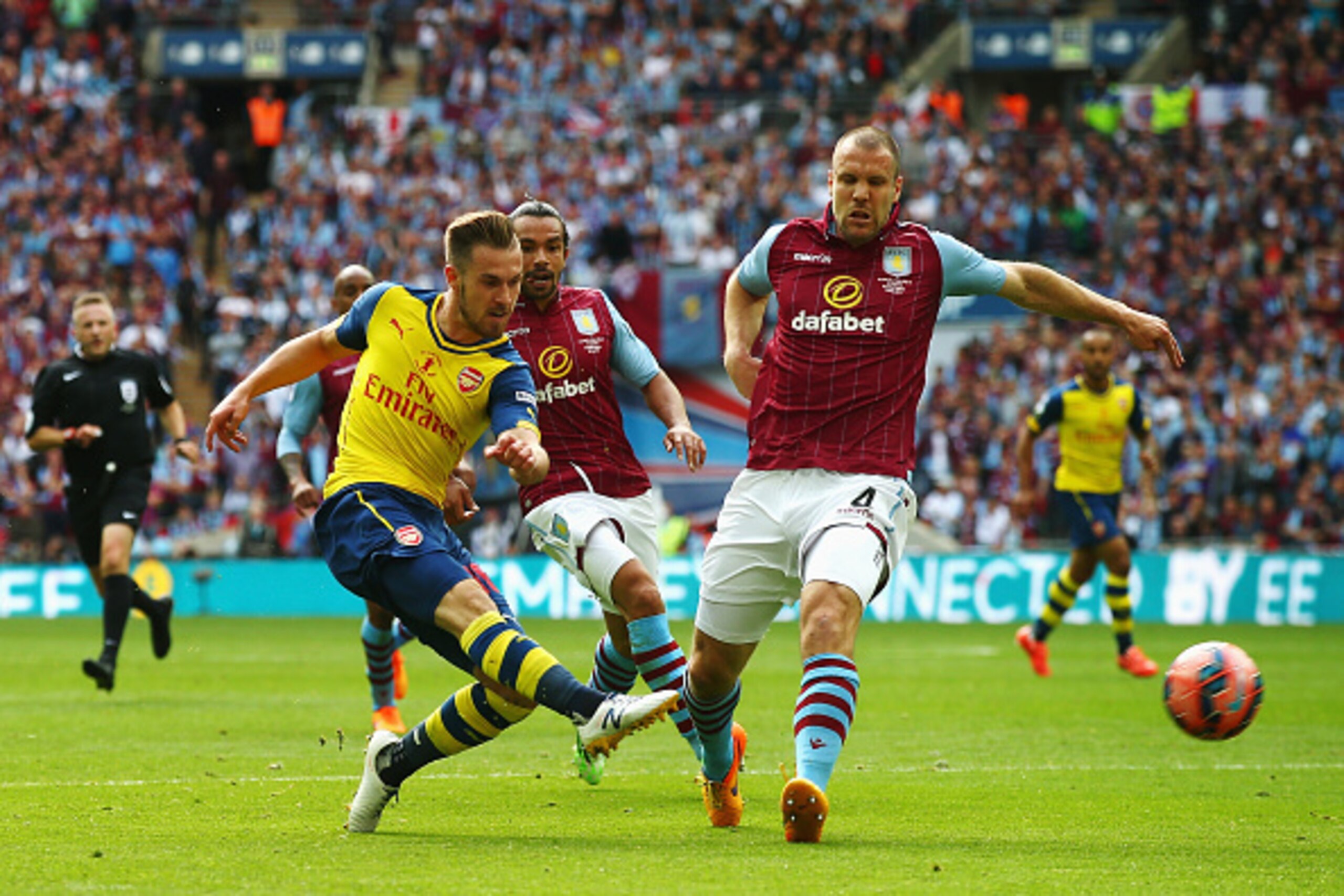 LONDON, ENGLAND - MAY 30:  Aaron Ramsey of Arsenal shoots past Ron Vlaar of Aston Villa during the FA Cup Final between Aston Villa and Arsenal at Wembley Stadium on May 30, 2015 in London, England.  (Photo by Clive Rose/Getty Images)