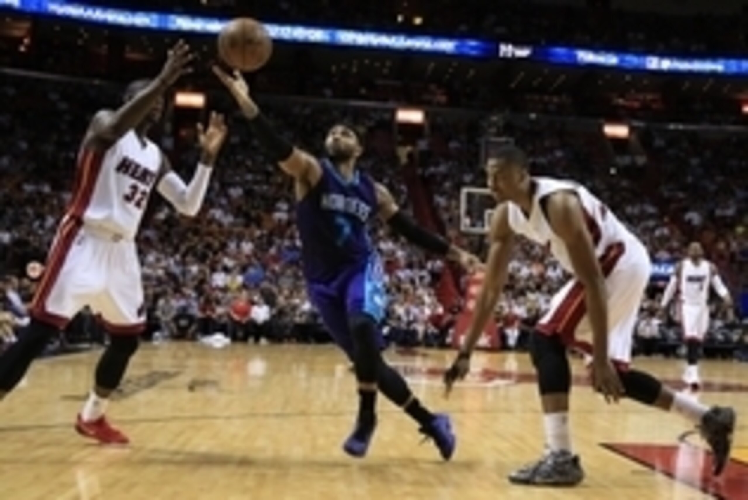 Apr 7, 2015; Miami, FL, USA;  Charlotte Hornets guard Mo Williams (7) battles Miami Heat forward James Ennis (32) and center Hassan Whiteside (21) for a loose ball in the second half at American Airlines Arena. The Heat won 105-100. Mandatory Credit: Robe
