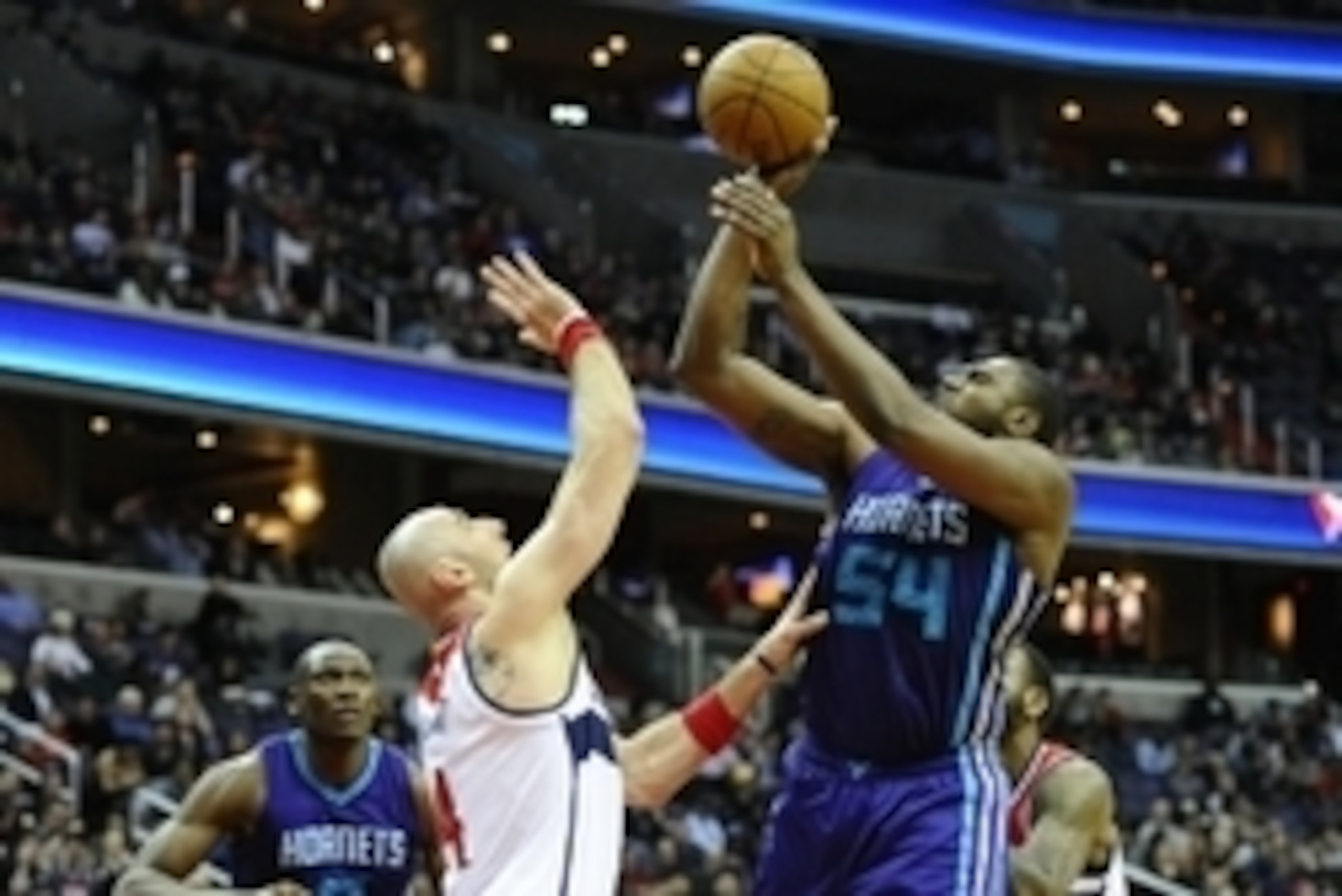 Mar 27, 2015; Washington, DC, USA; Charlotte Hornets forward Jason Maxiell (54) shoots over Washington Wizards center Marcin Gortat (4) during the second half at Verizon Center. The Wizards won in double overtime 110 - 107. Mandatory Credit: Brad Mills-US