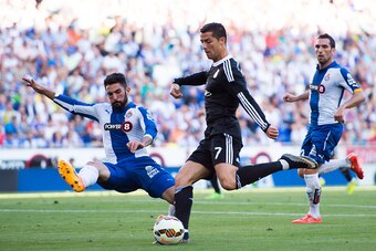 BARCELONA, SPAIN - MAY 17: Cristiano Ronaldo of Real Madrid CF kicks the ball next to Alvaro Gonzalez of RCD Espanyol during the La Liga match between RCD Espanyol and Real Madrid CF at Cornella-El Prat Stadium on May 17, 2015 in Barcelona, Spain. (Photo 