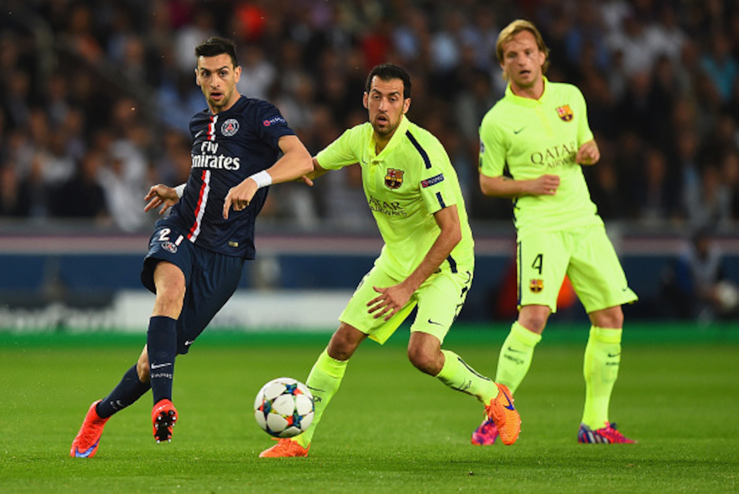 PARIS, FRANCE - APRIL 15:  Javier Pastore of PSG is challenged by Sergio Busquets of Barcelona  during the UEFA Champions League Quarter Final First Leg match between Paris Saint-Germain and FC Barcelona at Parc des Princes on April 15, 2015 in Paris, Fra