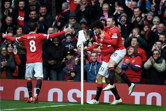 MANCHESTER, ENGLAND - MARCH 15:  Marouane Fellaini (C) of Manchester United is congratulated by teammates Juan Mata (L) of Manchester United and Wayne Rooney (R) of Manchester United after scoring the opening goal during the Barclays Premier League match 