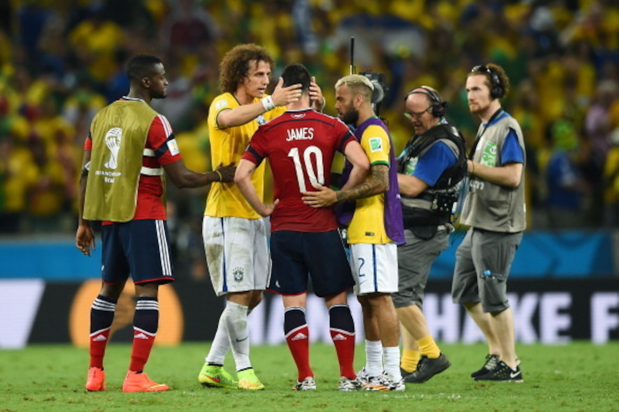 FORTALEZA, BRAZIL - JULY 04:  James Rodriguez of Colombia is consoled by David Luiz (L) and Dani Alves of Brazil after the 2014 FIFA World Cup Brazil Quarter Final match between Brazil and Colombia at Castelao on July 4, 2014 in Fortaleza, Brazil.  (Photo