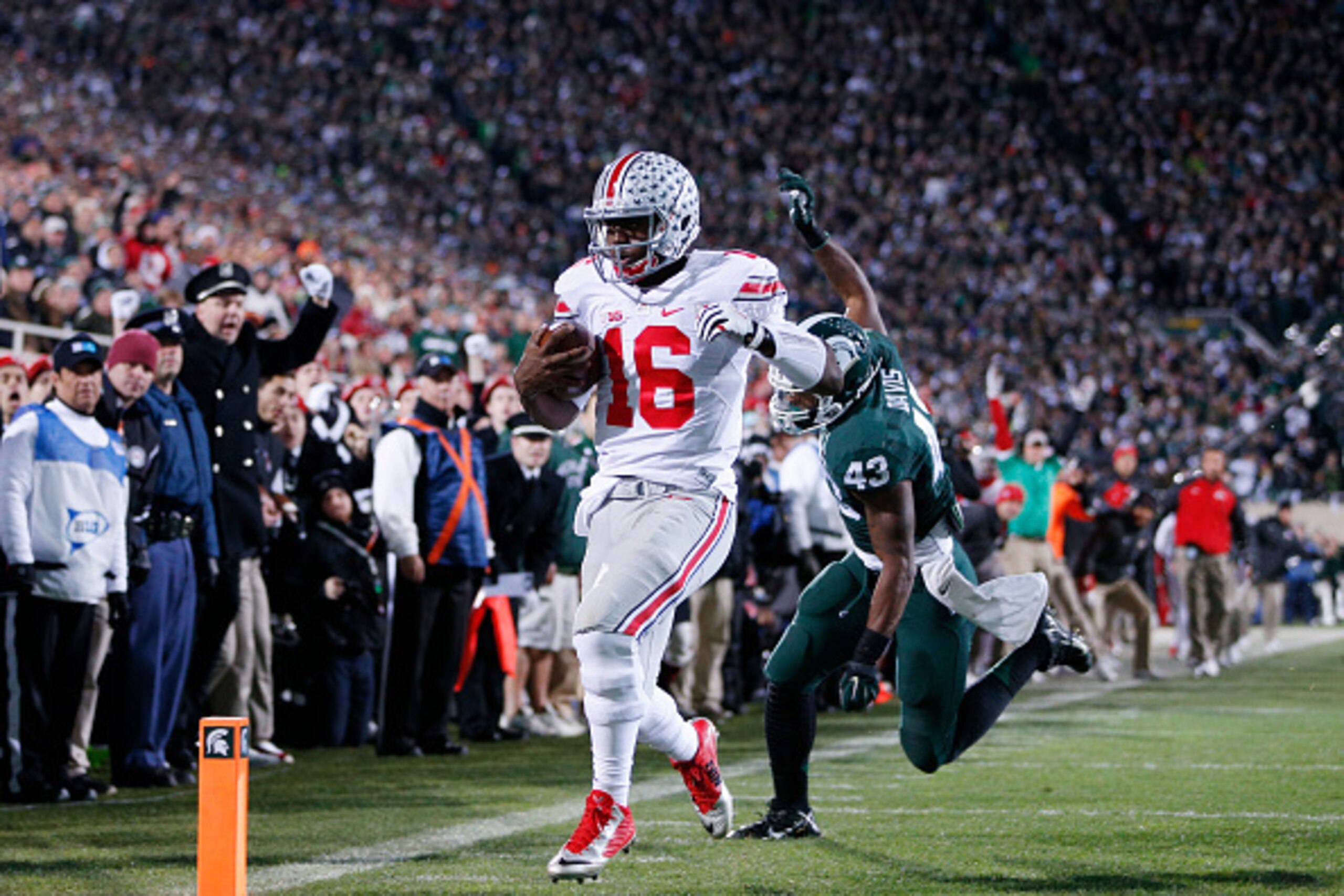 EAST LANSING, MI - NOVEMBER 8: J.T. Barrett #16 of the Ohio State Buckeyes runs for a five-yard touchdown in the first quarter of the game against the Michigan State Spartans at Spartan Stadium on November 8, 2014 in East Lansing, Michigan. (Photo by Joe 