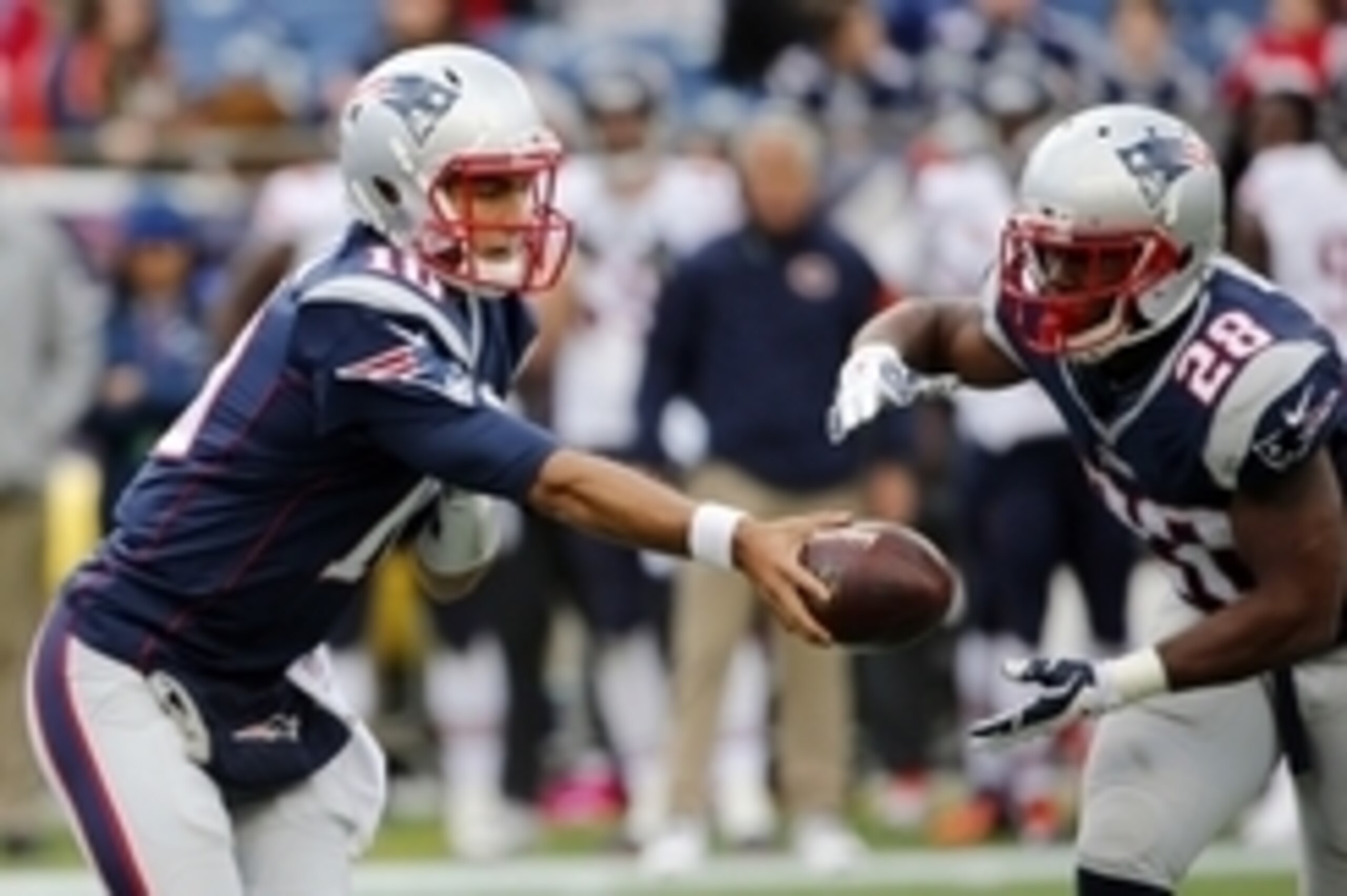 Oct 26, 2014; Foxborough, MA, USA; New England Patriots quarterback Jimmy Garoppolo (10) hands the ball off to running back James White (28) during the second half of New England's 51-23 win over the Chicago Bears at Gillette Stadium. Mandatory Credit: Wi