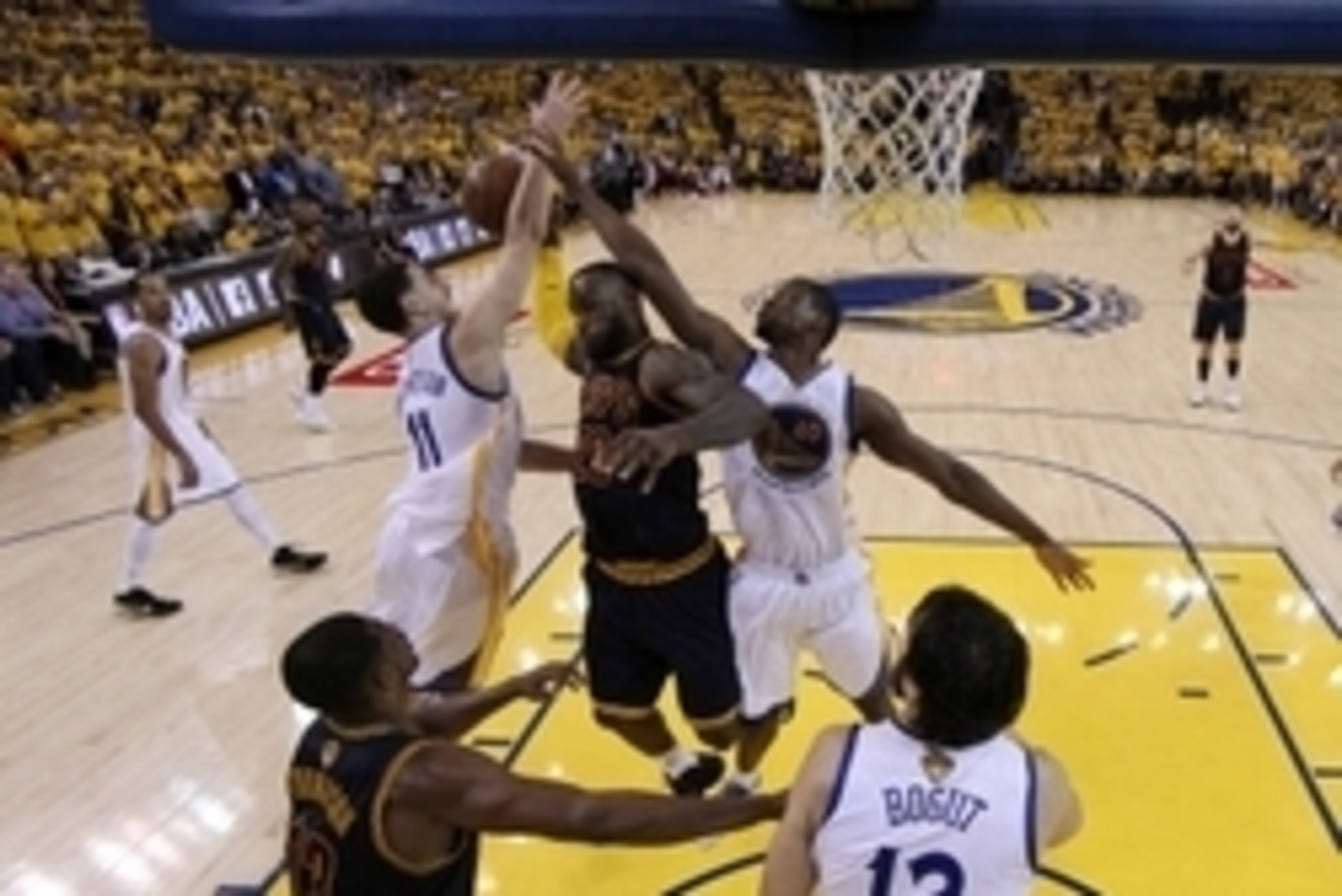 Jun 7, 2015; Oakland, CA, USA; Cleveland Cavaliers forward LeBron James (23) goes for a rebound against Golden State Warriors guard Klay Thompson (11) and forward Harrison Barnes (40) in game two of the NBA Finals at Oracle Arena. Mandatory Credit: Ezra S