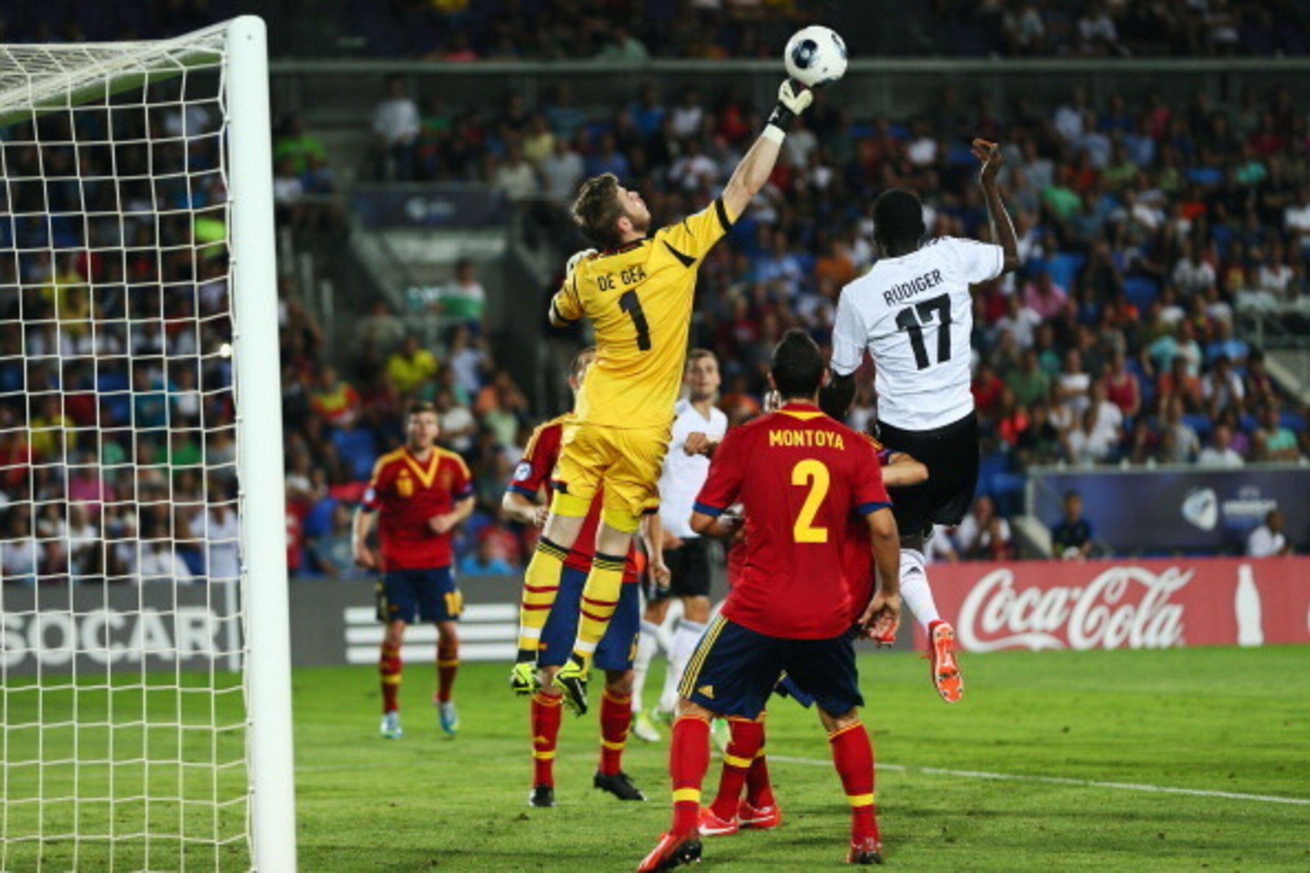 NETANYA, ISRAEL - JUNE 09: Goalkeeper David de Gea of Spain clears the ball ahead of Antonio Ruediger of Germany during the UEFA European U21 Champiosnship Group B match between Germany and Spain at Netanya Stadium on June 9, 2013 in Netanya, Israel.  (Ph