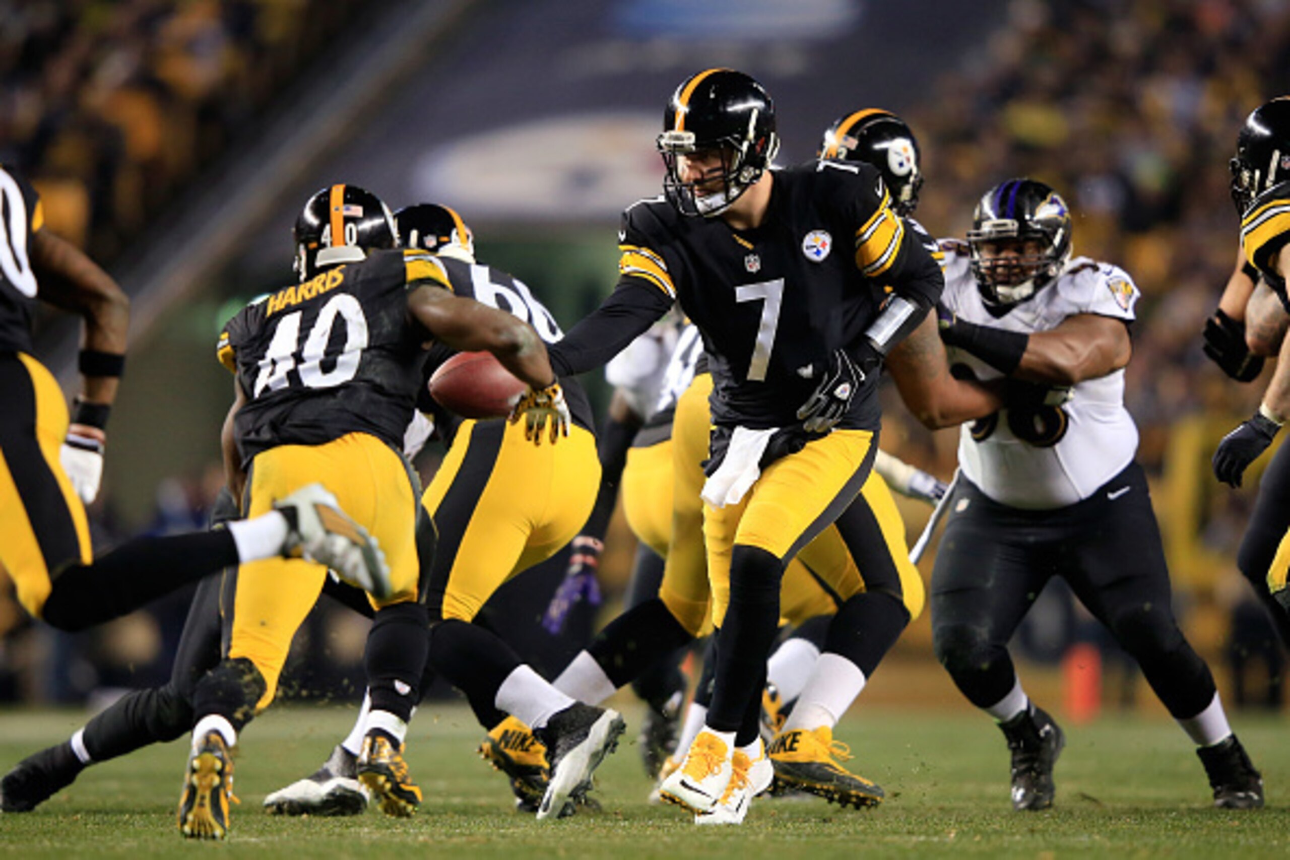 PITTSBURGH, PA - JANUARY 03:  Ben Roethlisberger #7 hands off to Josh Harris #40 of the Pittsburgh Steelers against the Baltimore Ravens during their AFC Wild Card game at Heinz Field on January 3, 2015 in Pittsburgh, Pennsylvania.  (Photo by Jamie Squire