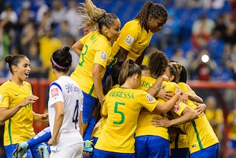 MONTREAL, QC - JUNE 09:  Marta #10 of Brazil celebrates a goal on a penalty kick with teammates in the second half during the 2015 FIFA Women's World Cup Group E match against Korea Republic at Olympic Stadium on June 9, 2015 in Montreal, Quebec, Canada. 
