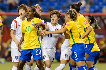 MONTREAL, QC - JUNE 09:  Members from Brazil and Korea Republic battle for position in the first half during the 2015 FIFA Women's World Cup Group E match at Olympic Stadium on June 9, 2015 in Montreal, Quebec, Canada. (Photo by Minas Panagiotakis/Getty I