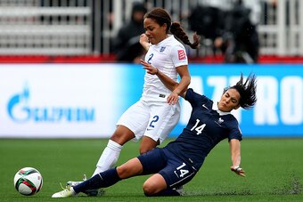 MONCTON, NB - JUNE 09:  Louisa Necib #14 of France knocks the ball away from Alex Scott #2 of England during the FIFA Women's World Cup 2015 Group F match at Moncton Stadium on June 9, 2015 in Moncton, Canada.  (Photo by Elsa/Getty Images)