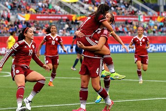 MONCTON, NB - JUNE 09:  Veronica Perez #17 of Mexico celebrates with Alina Garciamendez #4 and Renae Cuellar #19 after she scored in the first half against Colombia during the FIFA Women's World Cup 2015 Group F match at Moncton Stadium on June 9, 2015 in