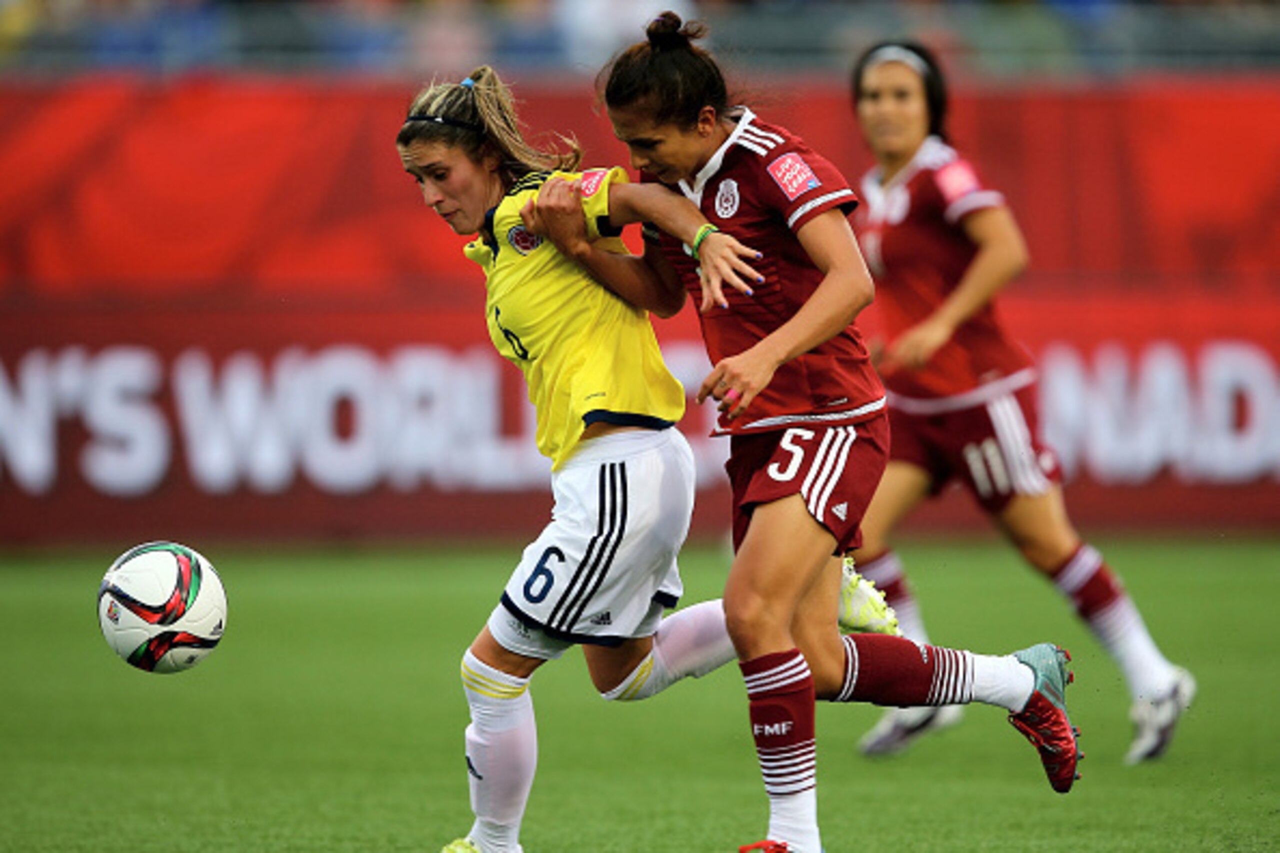 MONCTON, NB - JUNE 09:  Daniela Montoya #6 of Colombia and Valeria Miranda #5 of Mexico fight for the ball in the second half during the FIFA Women's World Cup 2015 Group F match at Moncton Stadium on June 9, 2015 in Moncton, Canada.  (Photo by Elsa/Getty
