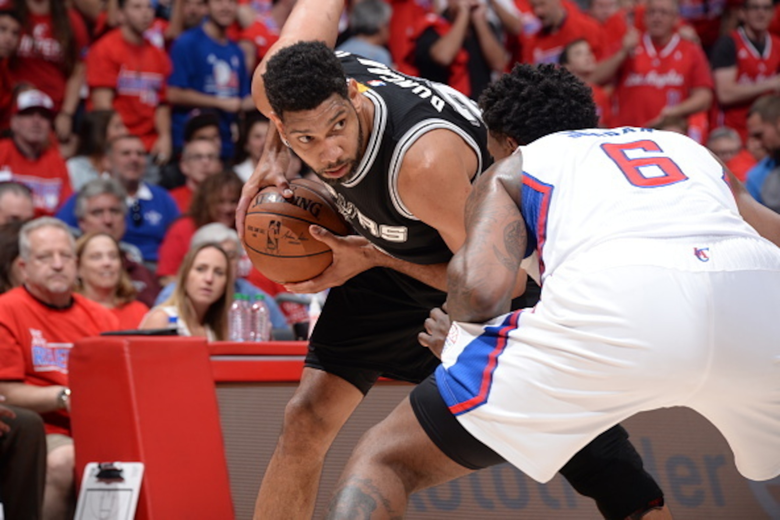 LOS ANGELES, CA - May 2: Tim Duncan #21 of the San Antonio Spurs handles the ball against DeAndre Jordan #6 of the Los Angeles Clippers in Game Seven of the Western Conference Quarterfinals during the 2015 NBA Playoffs on May 2, 2015 at Staples Center in LOS ANGELES, CA - May 2: Tim Duncan #21 of the San Antonio Spurs handles the ball against DeAndre Jordan #6 of the Los Angeles Clippers in Game Seven of the Western Conference Quarterfinals during the 2015 NBA Playoffs on May 2, 2015 at Staples Center in